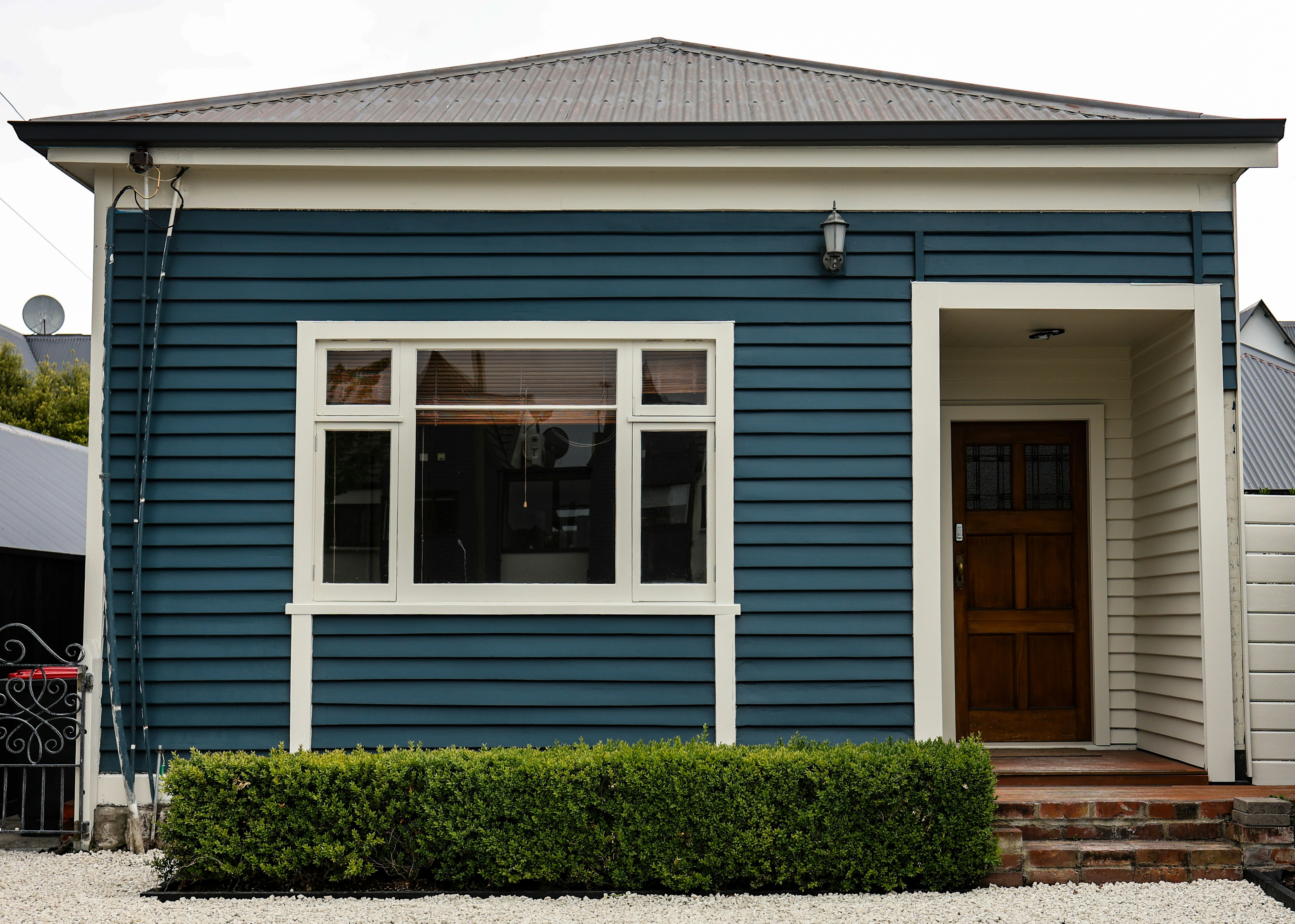 Home showcasing a unique Hardie siding color like Evening Blue or a green shade - 5 inch hardie siding