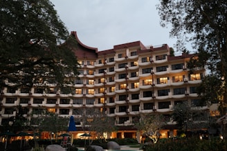 A large building with many windows lit up at night