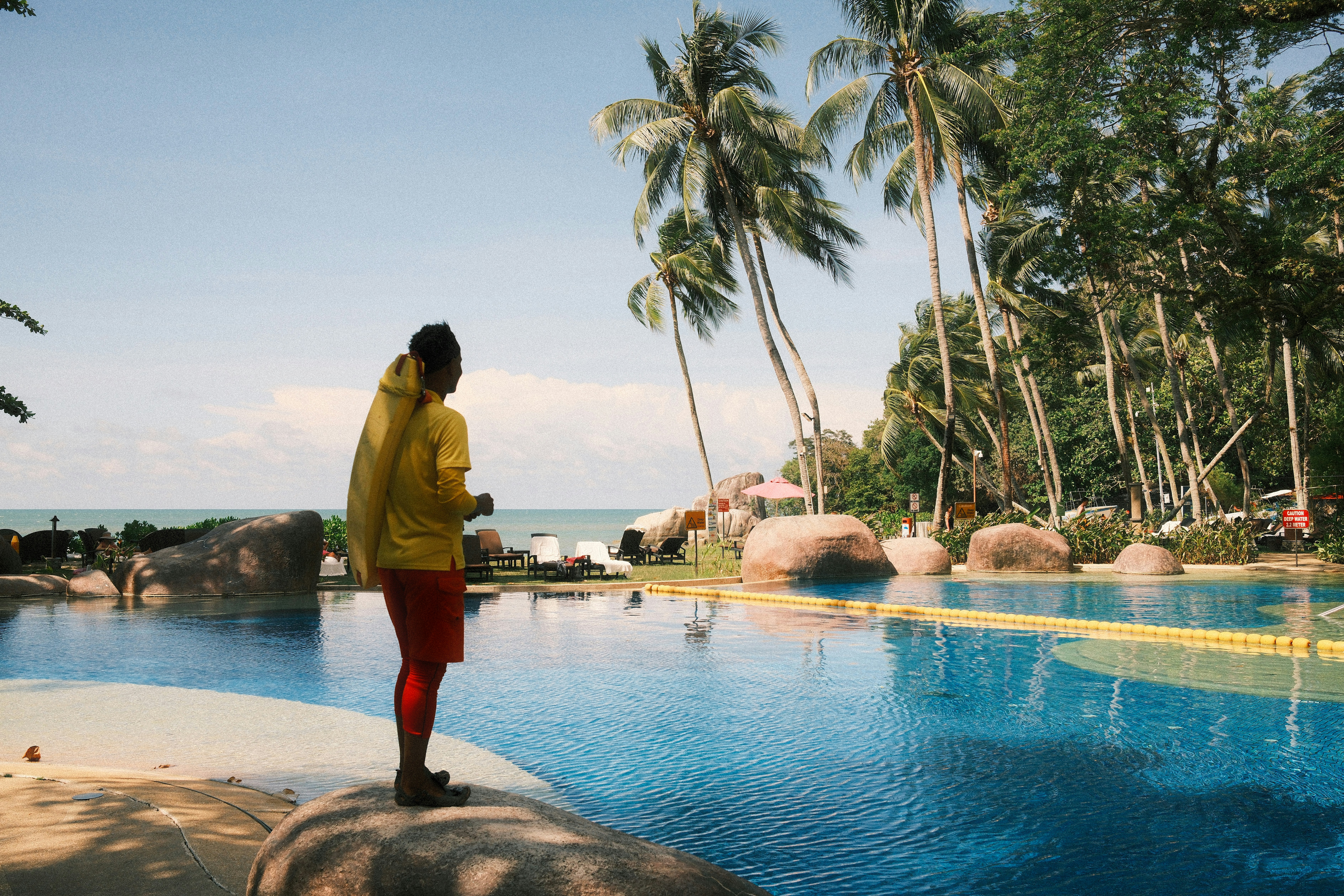 A woman standing on the edge of a swimming pool
