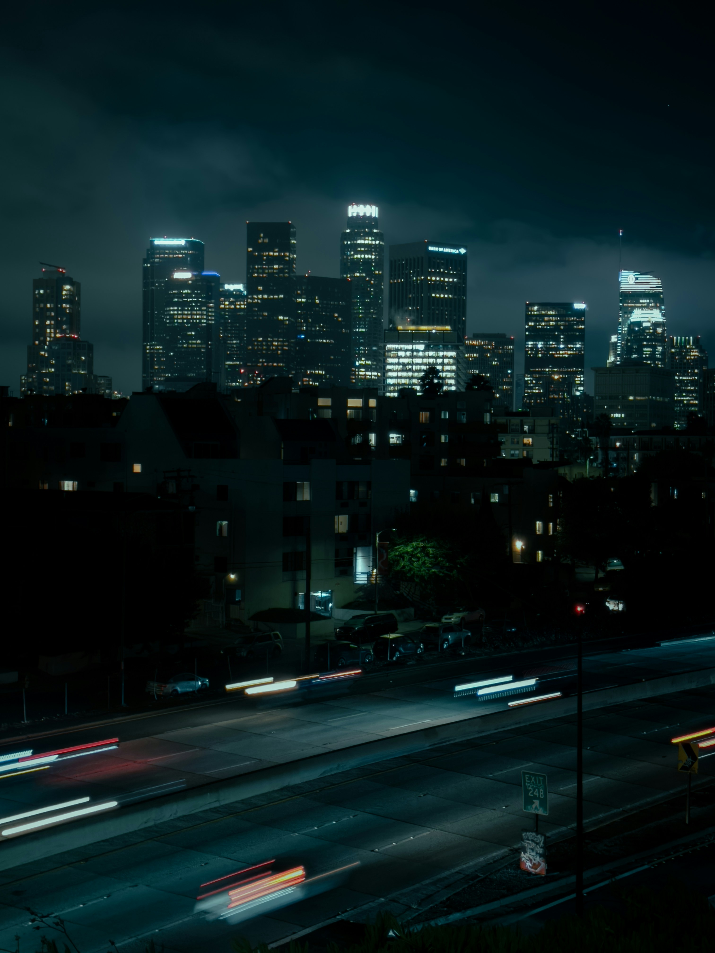 A city skyline at night with a lot of traffic