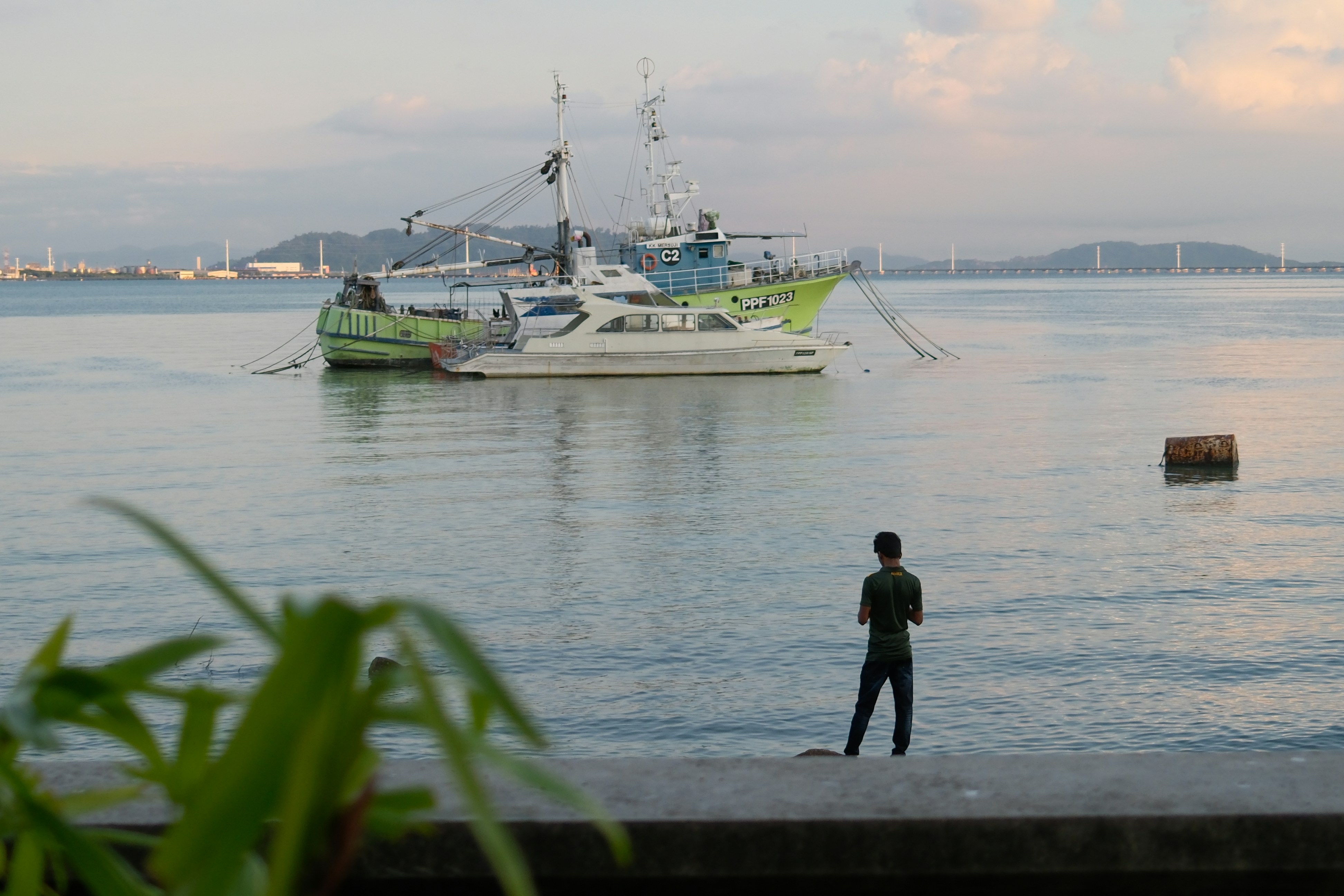 A man standing in front of a body of water