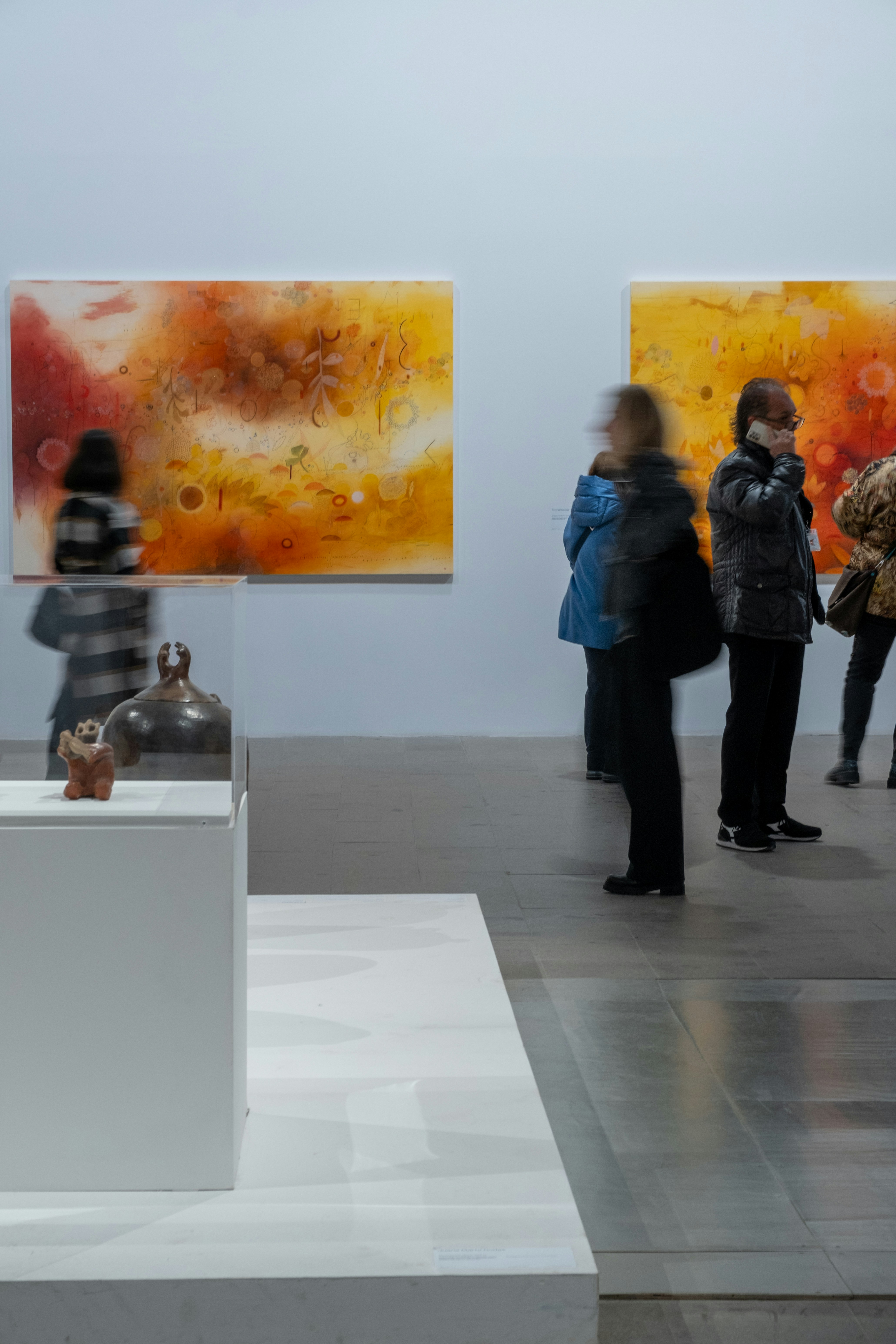 Abstract motion blur art installation, dark atmospheric gallery space, moody low-key lighting
