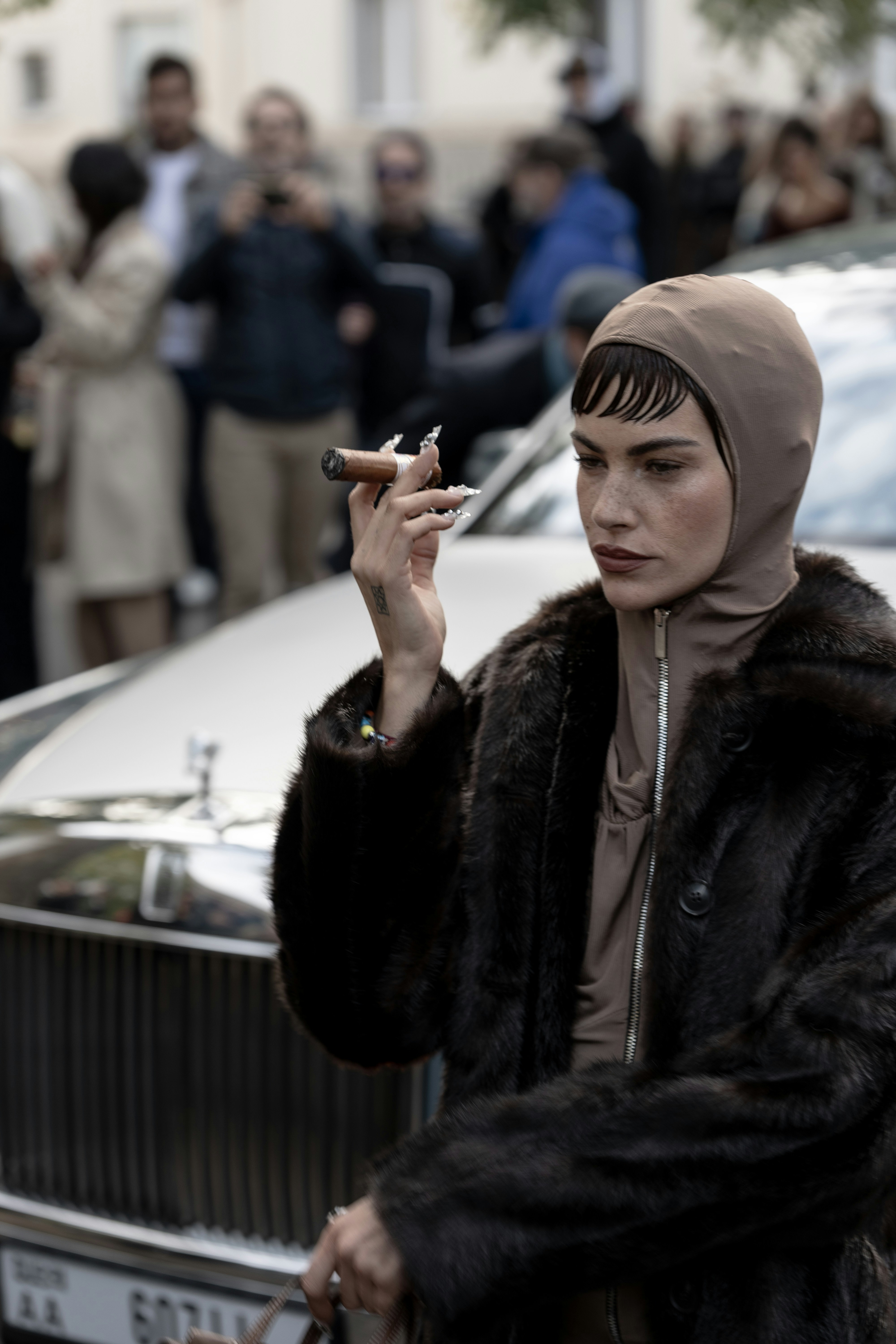 A woman in a fur coat smoking a cigarette photo – Free Paris Image on ...