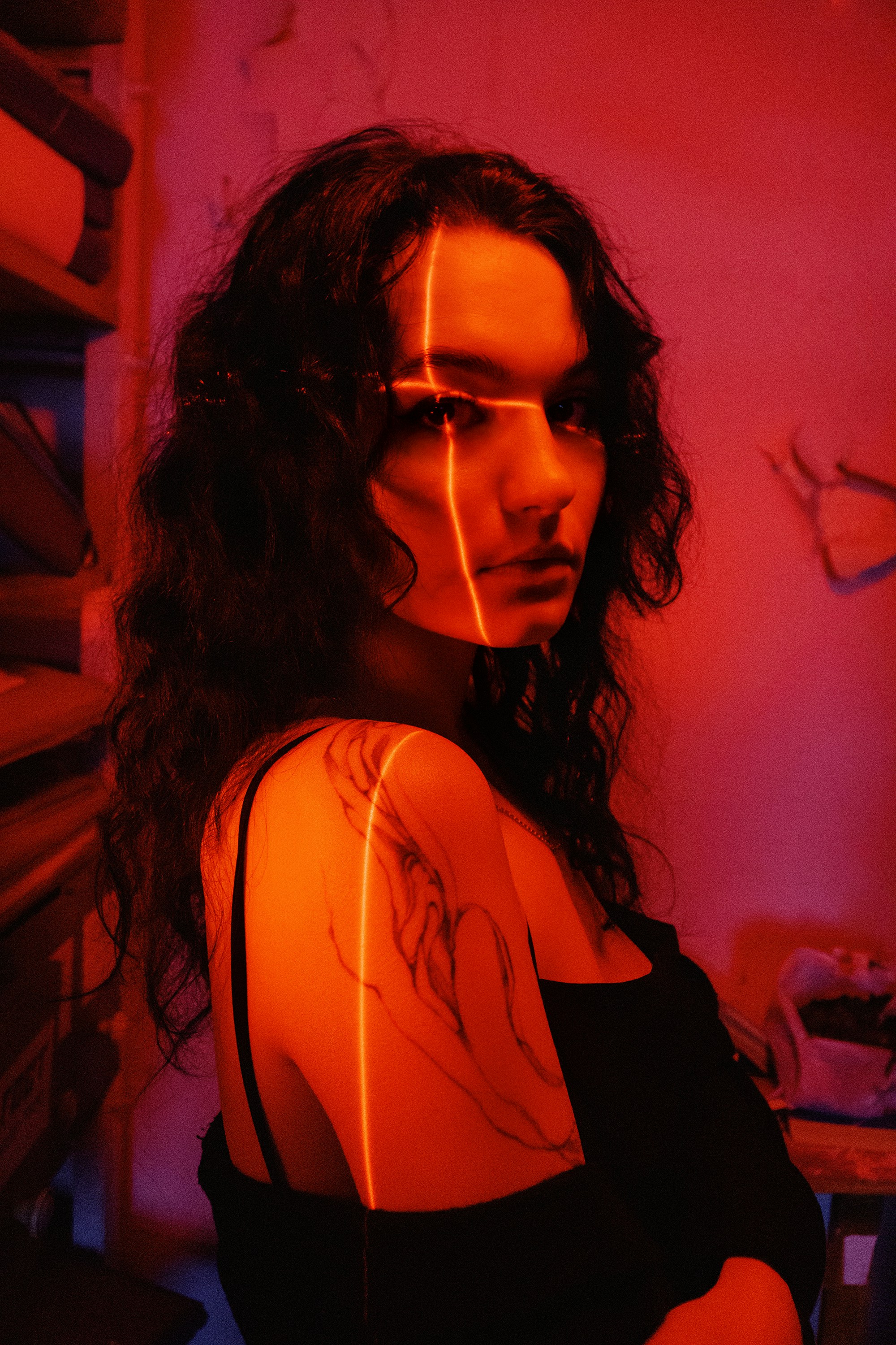 A woman standing in a room with red light