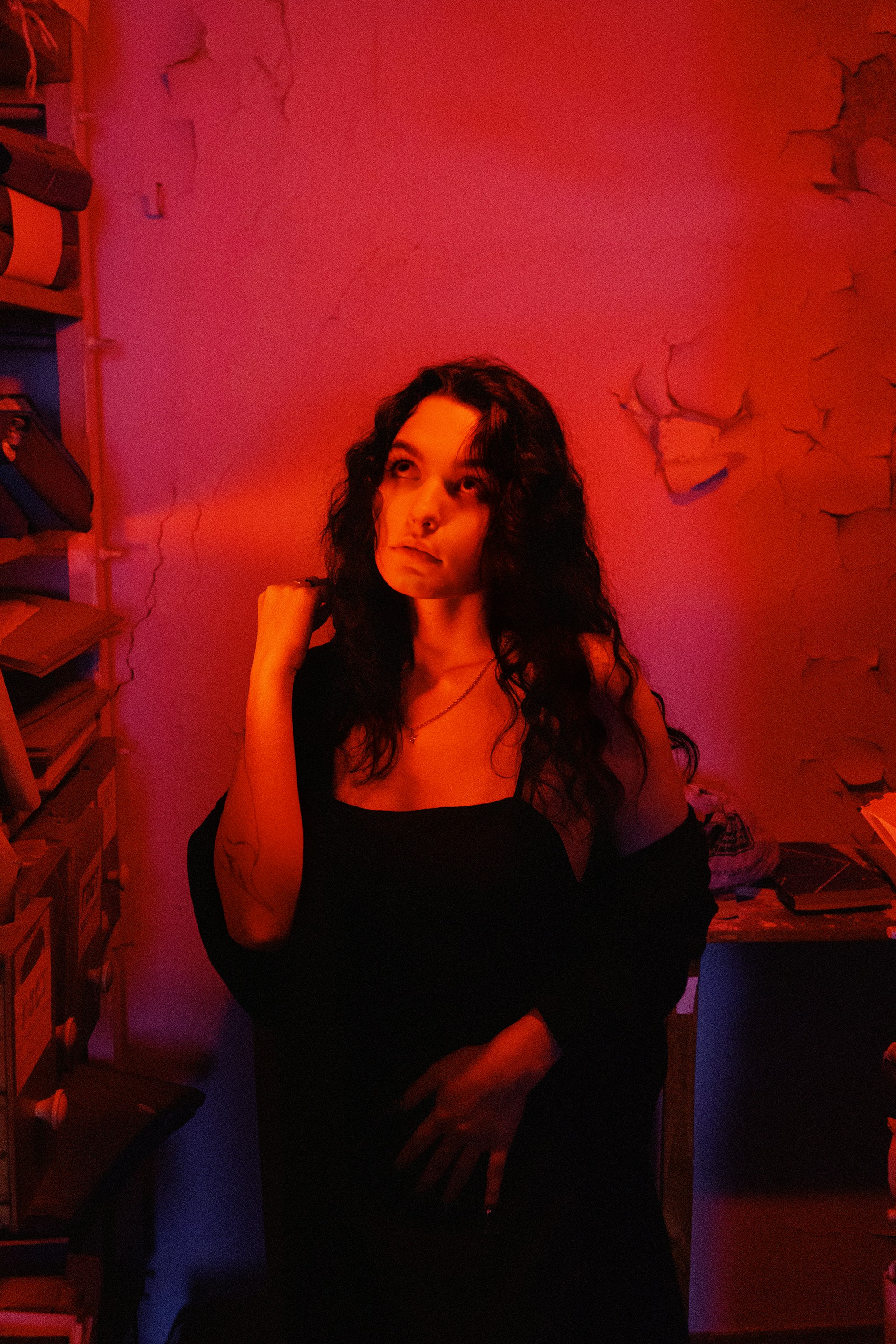 A woman standing in a room with a red light