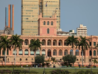 A large building with palm trees in front of it