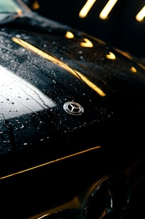 A close up of the hood of a black car