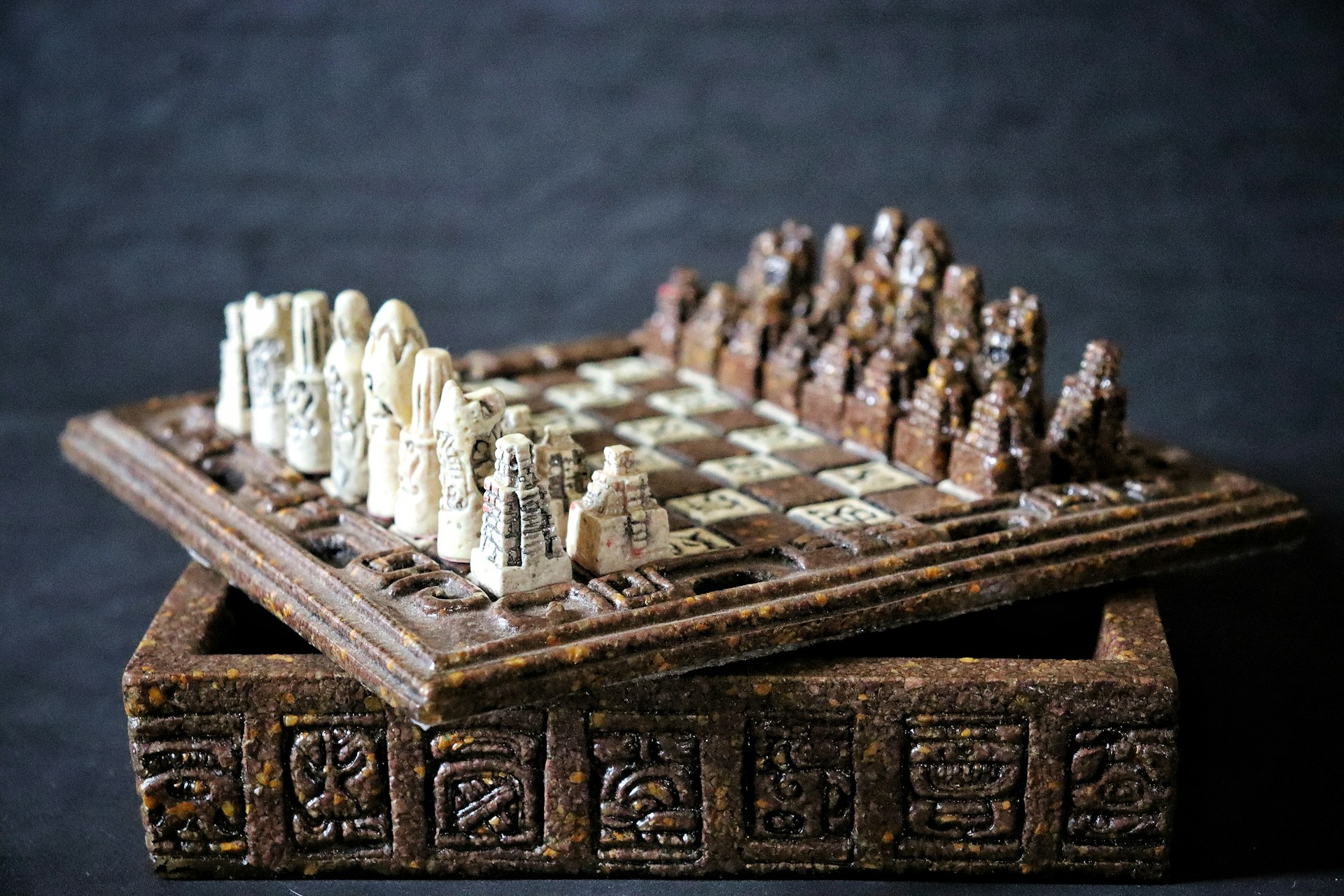 A wooden chess set sitting on top of a table
