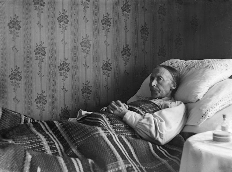 Persona anziana a letto coperta da una coperta
