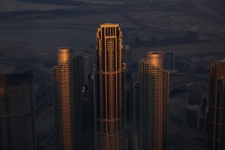 A view of a city at night from the top of a skyscraper