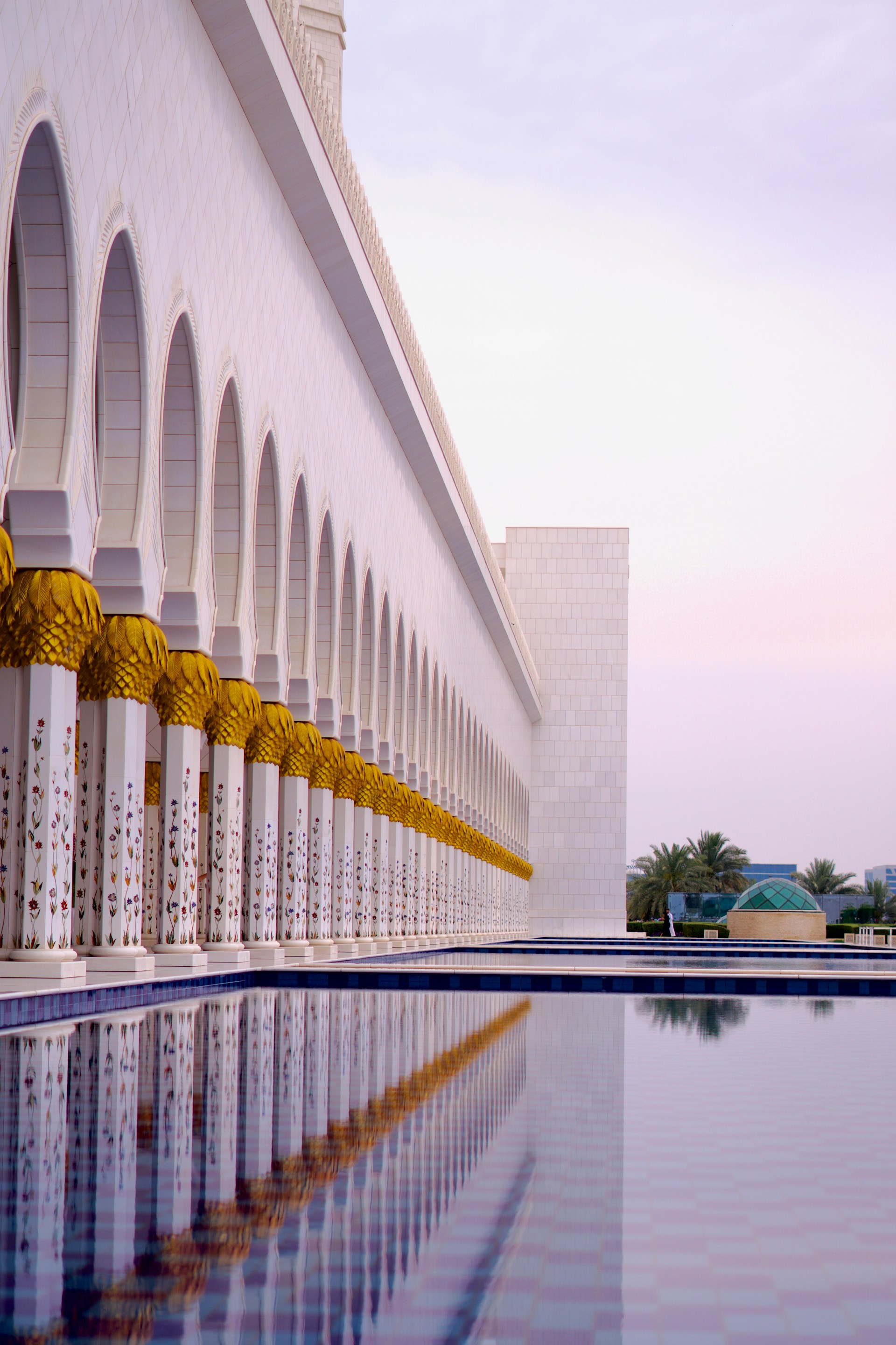 A large building with a pool in front of it