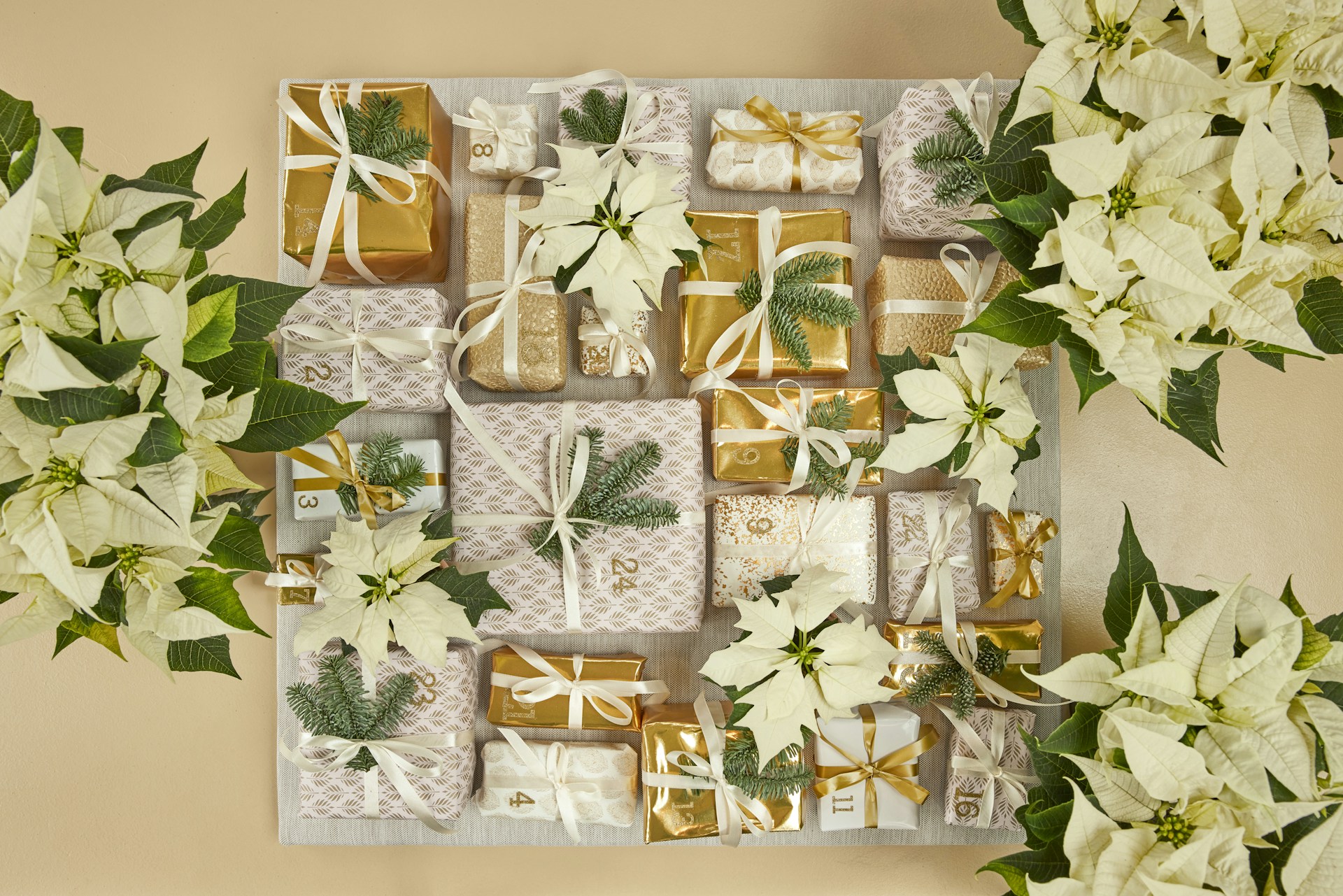A table topped with lots of white flowers and wrapped presents