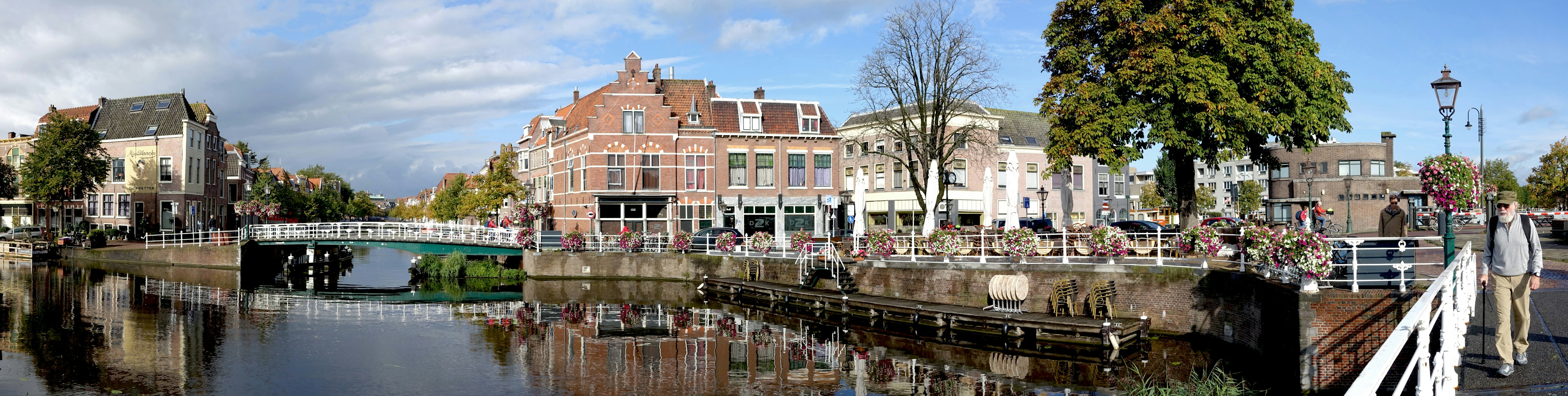 A view of a canal with a bridge in the background