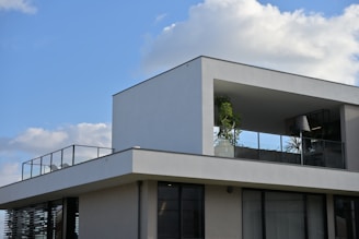 A large white building with a balcony and balconies