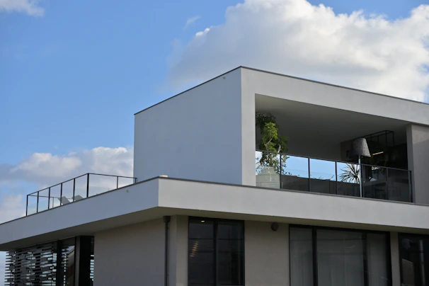 A large white building with a balcony and balconies