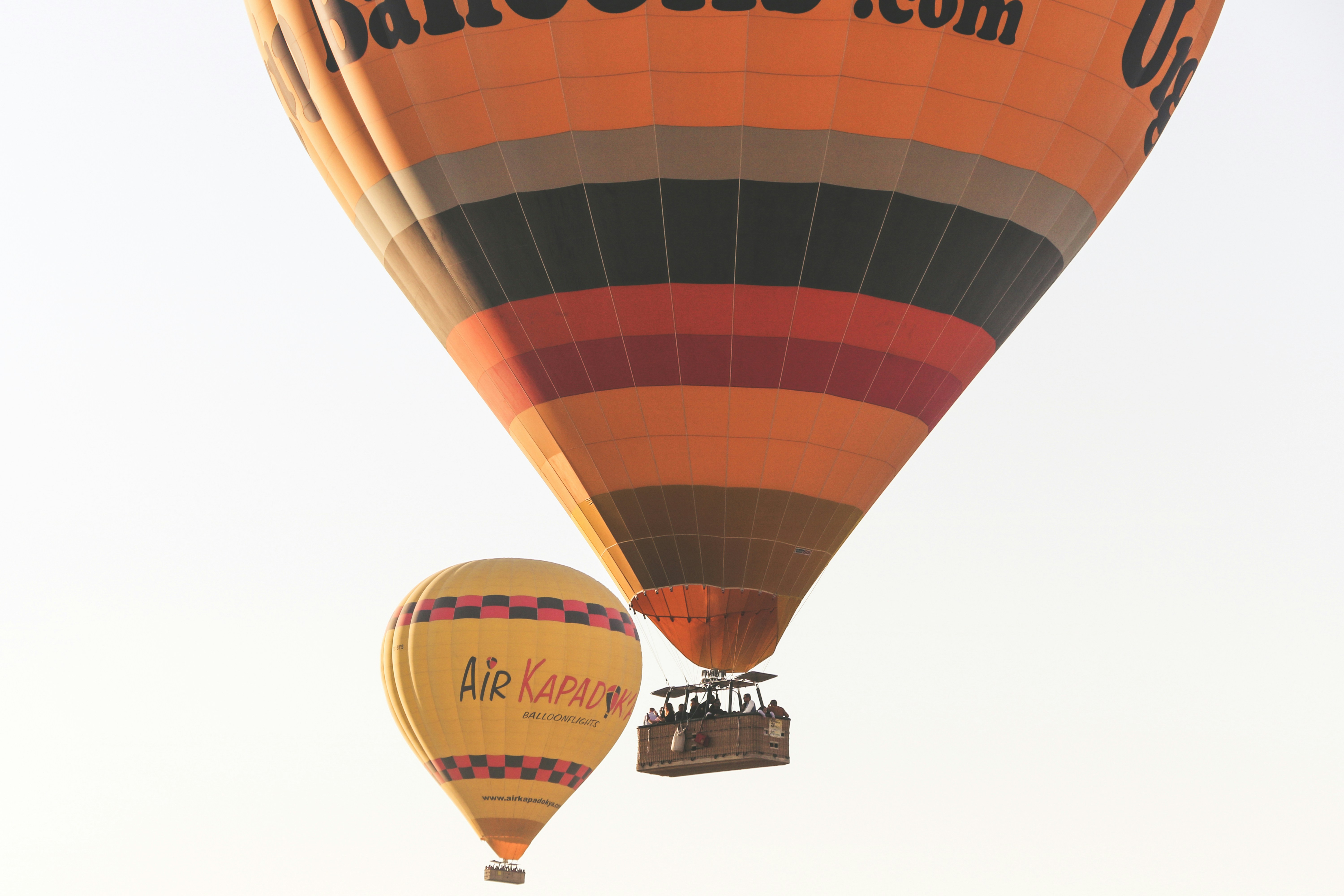 A couple of hot air balloons flying in the sky