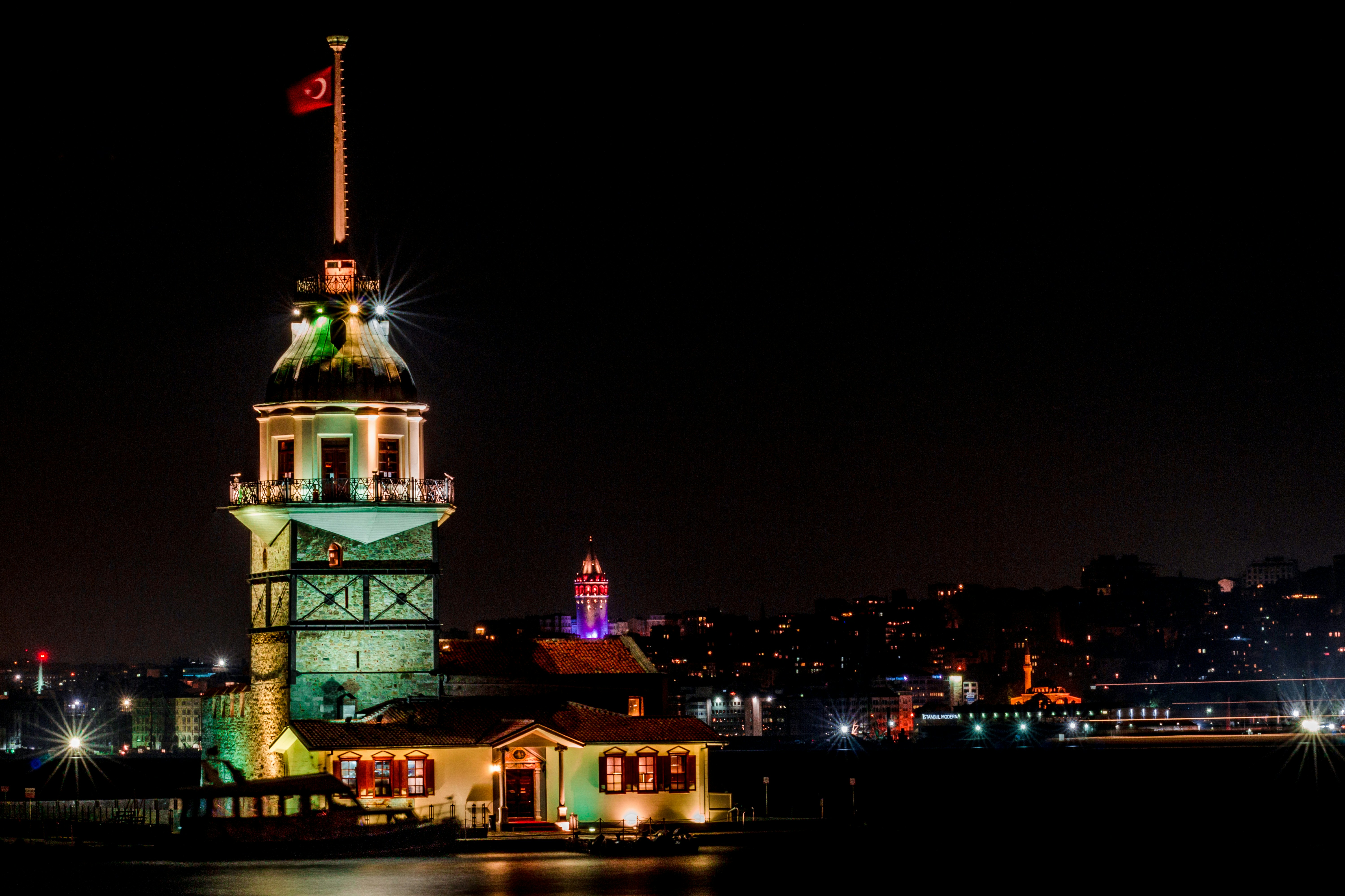 A large clock tower lit up at night