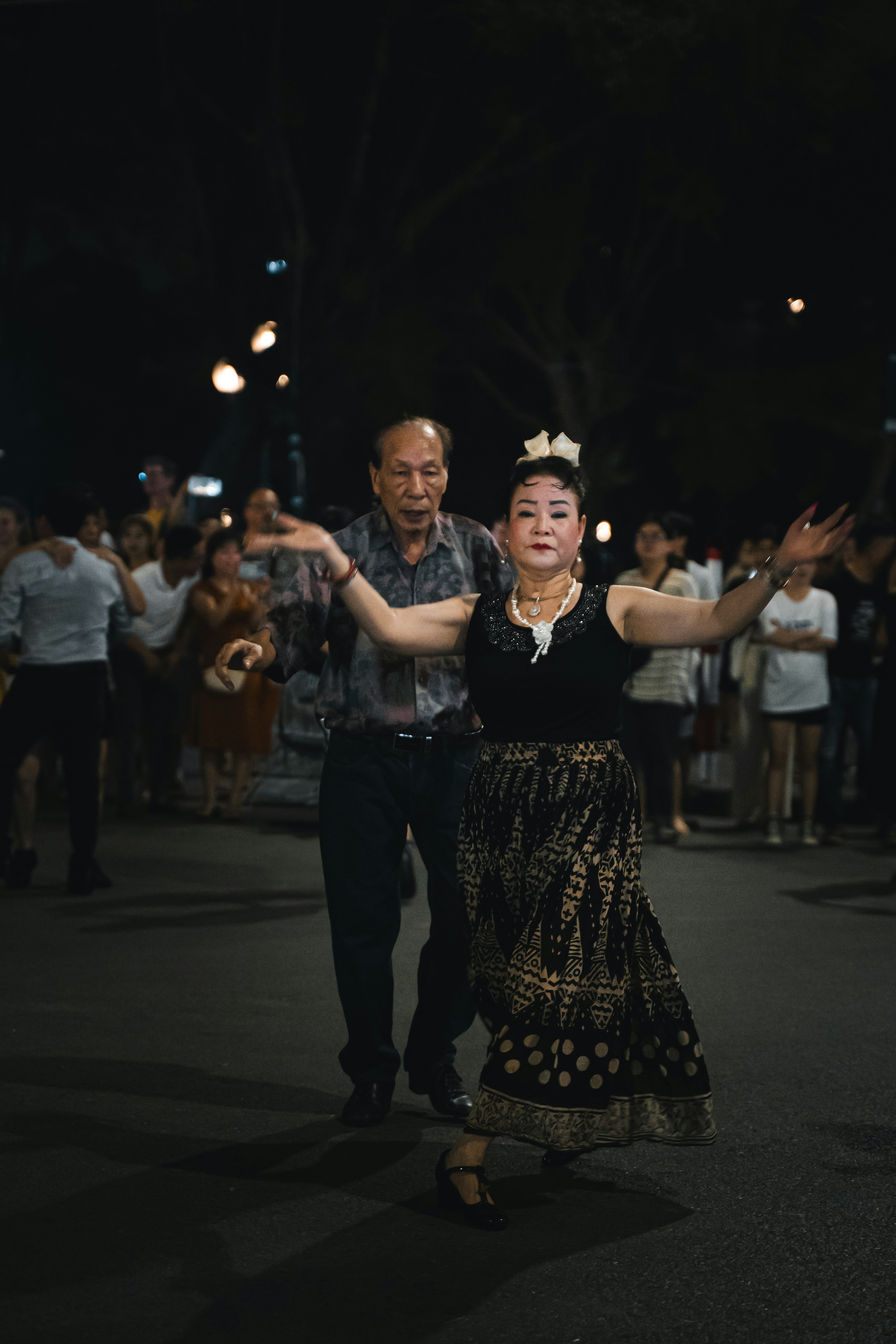 Why Some Viral TikTok Dances Disappear Overnight (And Which Ones Stick) – A man and a woman dancing in the street at night
