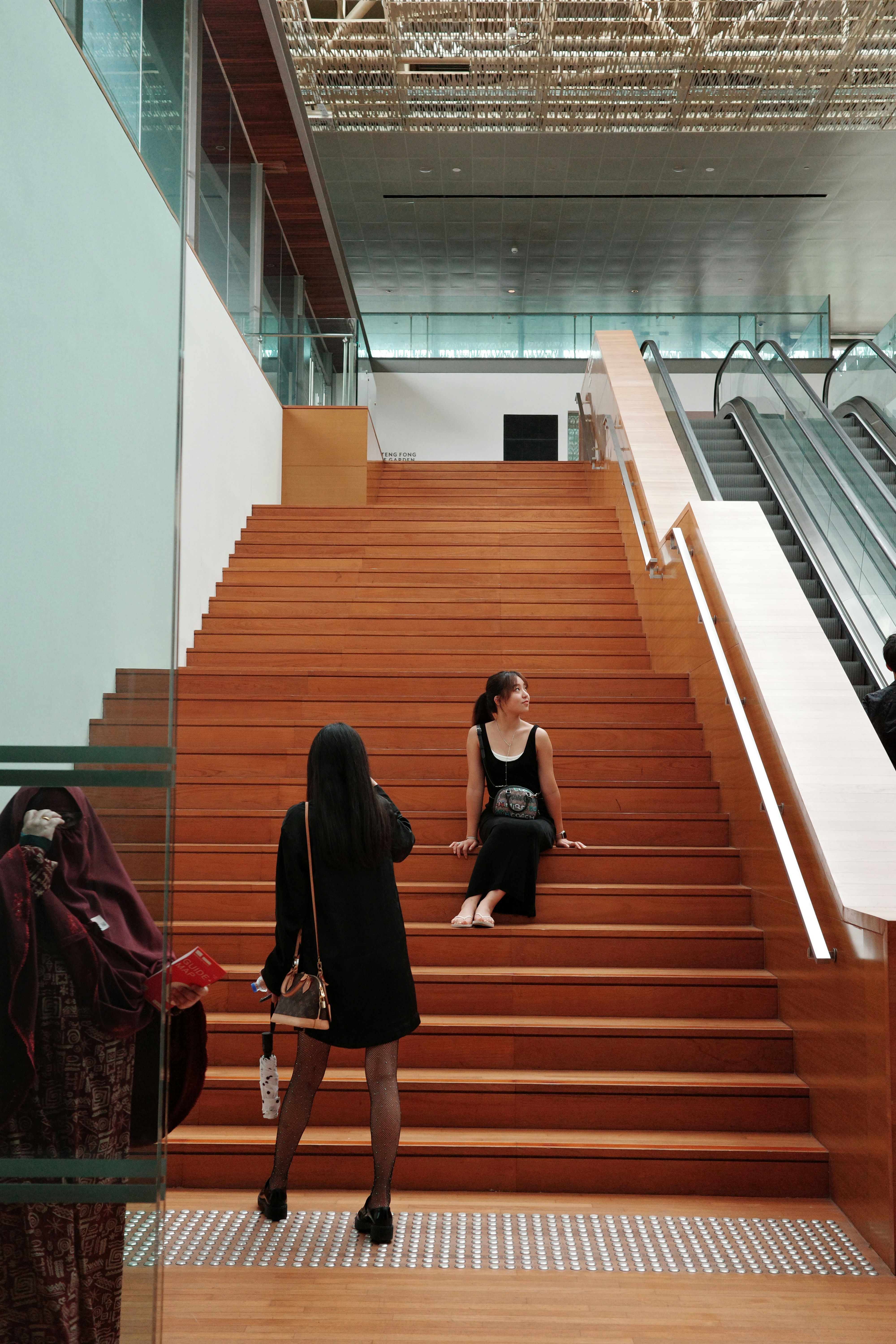 A group of people walking up and down a set of stairs