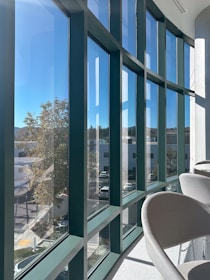 A room with a lot of windows and chairs