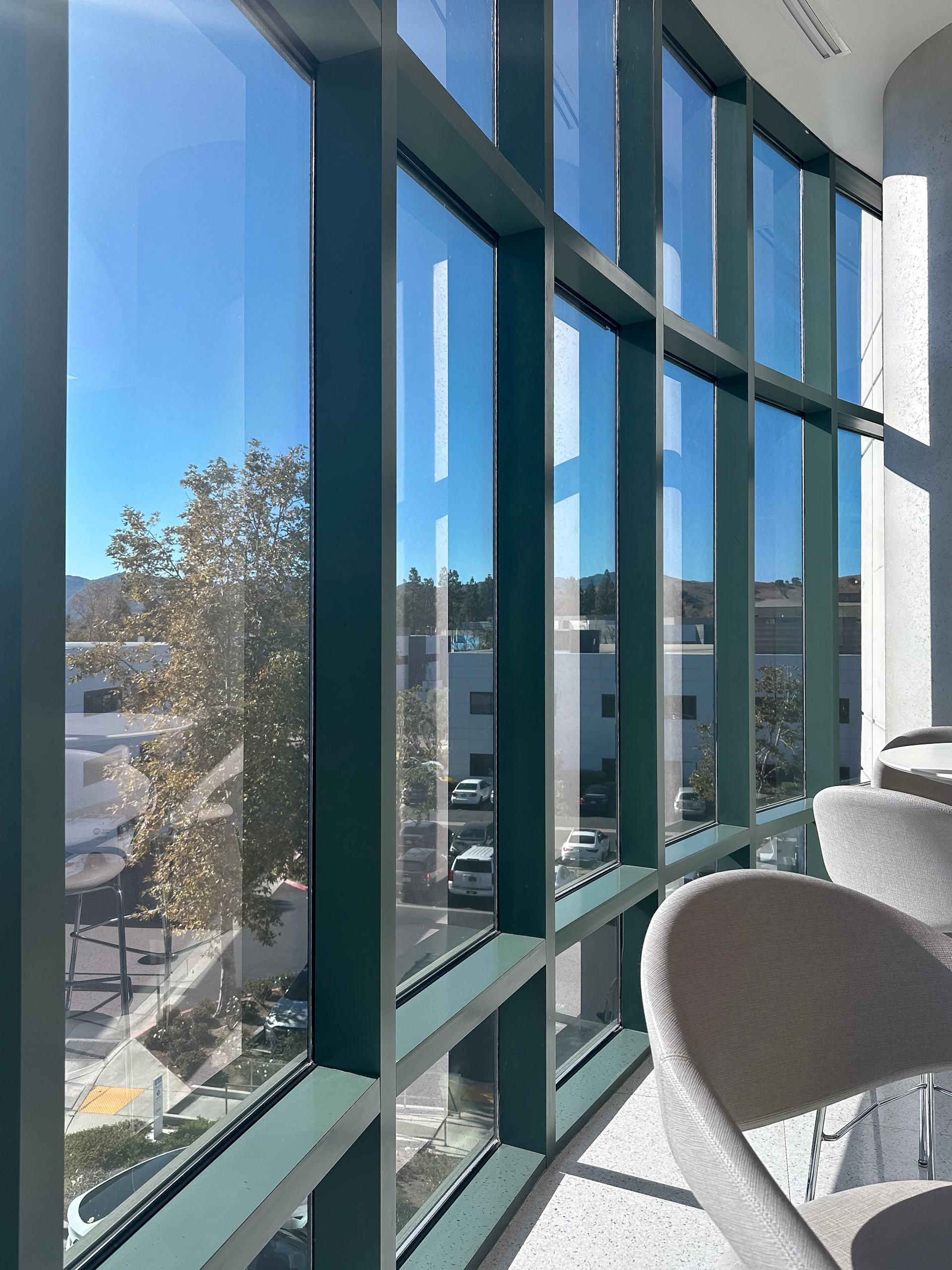 A room with a lot of windows and chairs