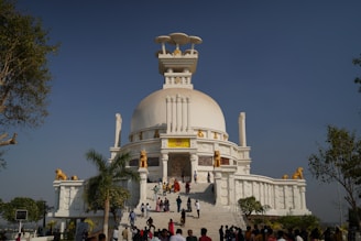 A group of people standing in front of a white building