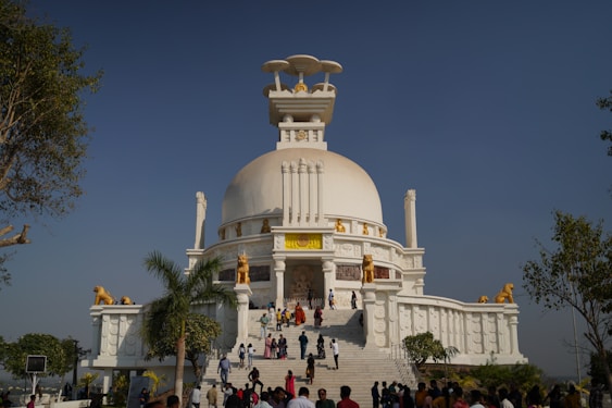 A group of people standing in front of a white building