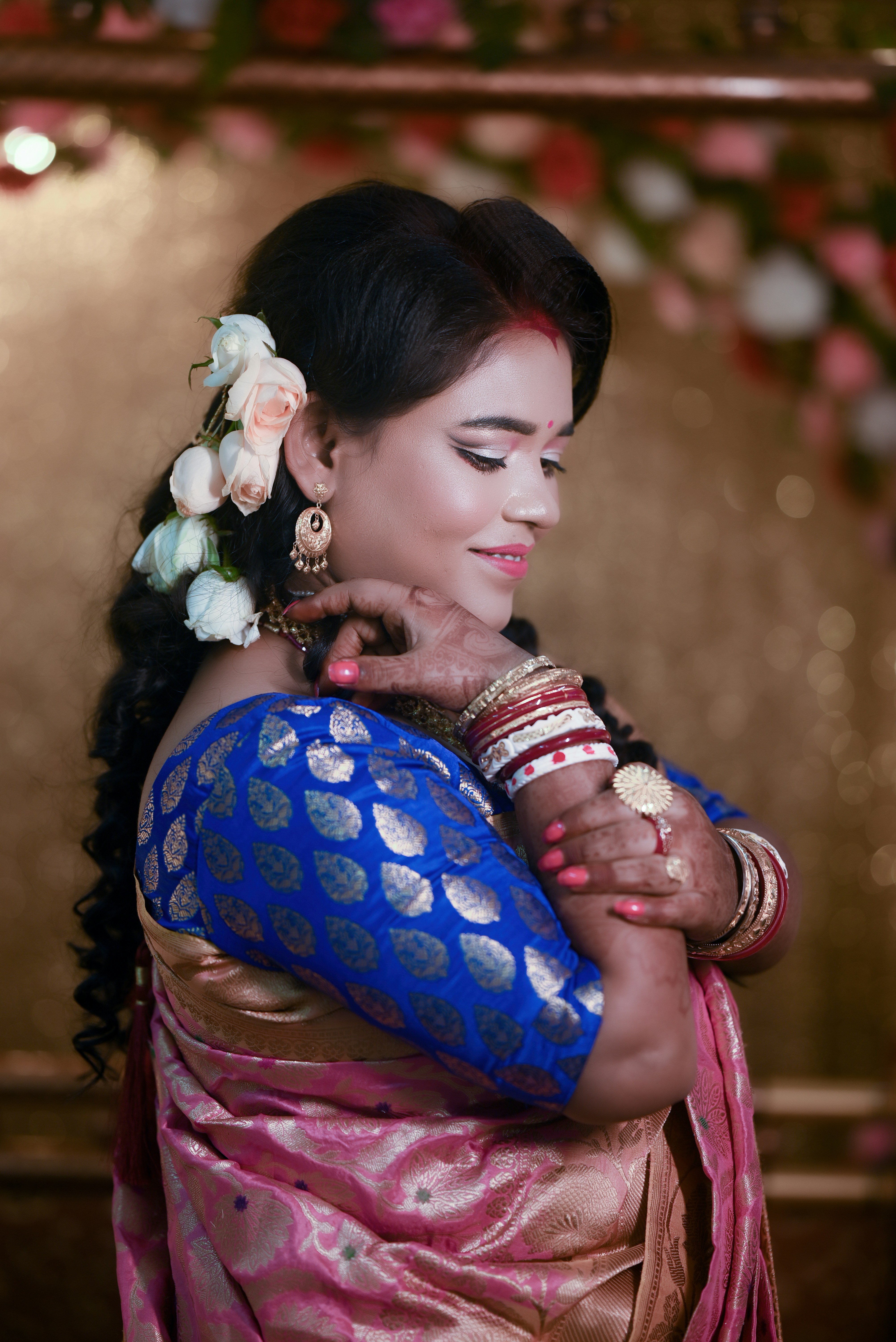 A woman in a blue and pink sari