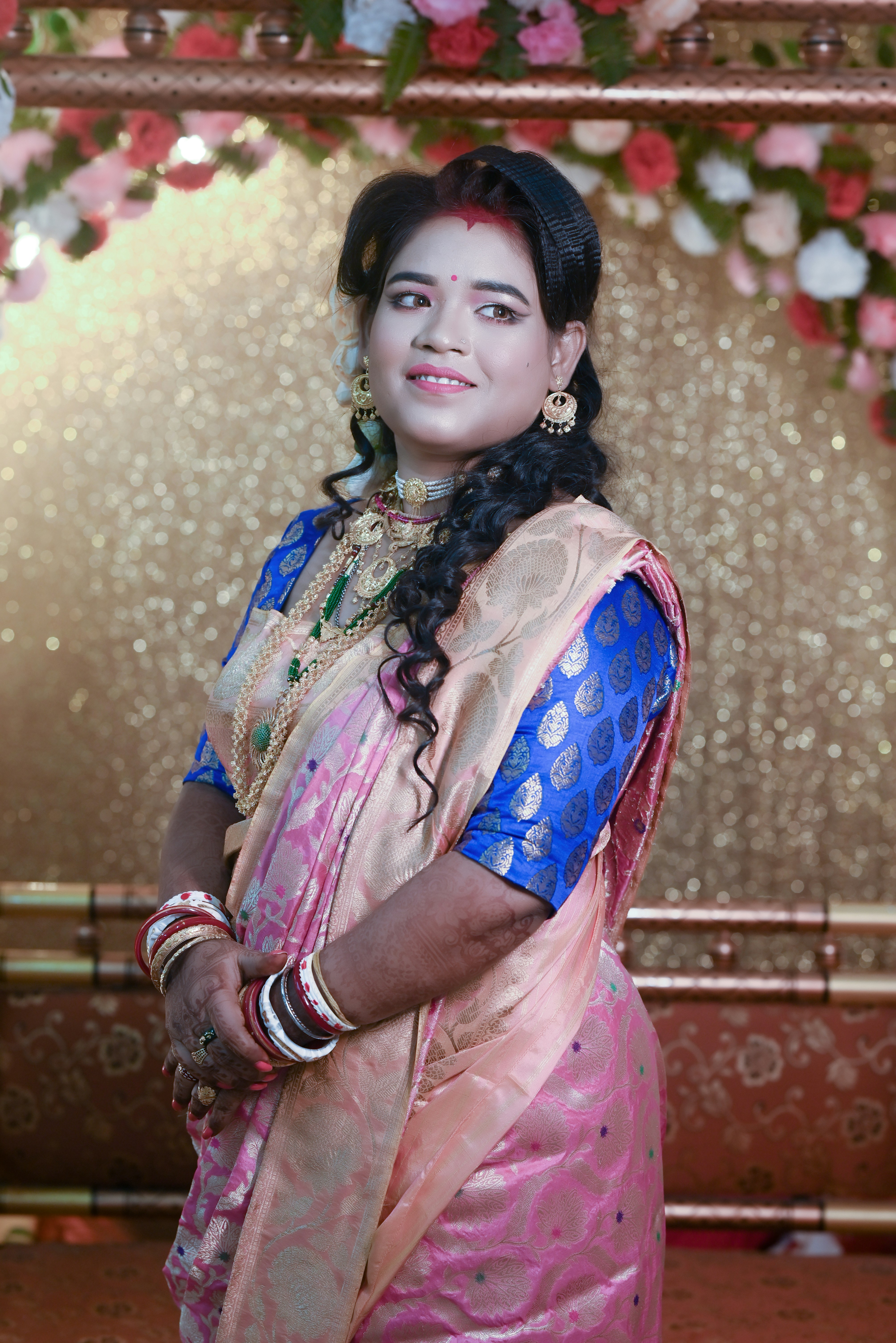 A woman in a pink and blue sari