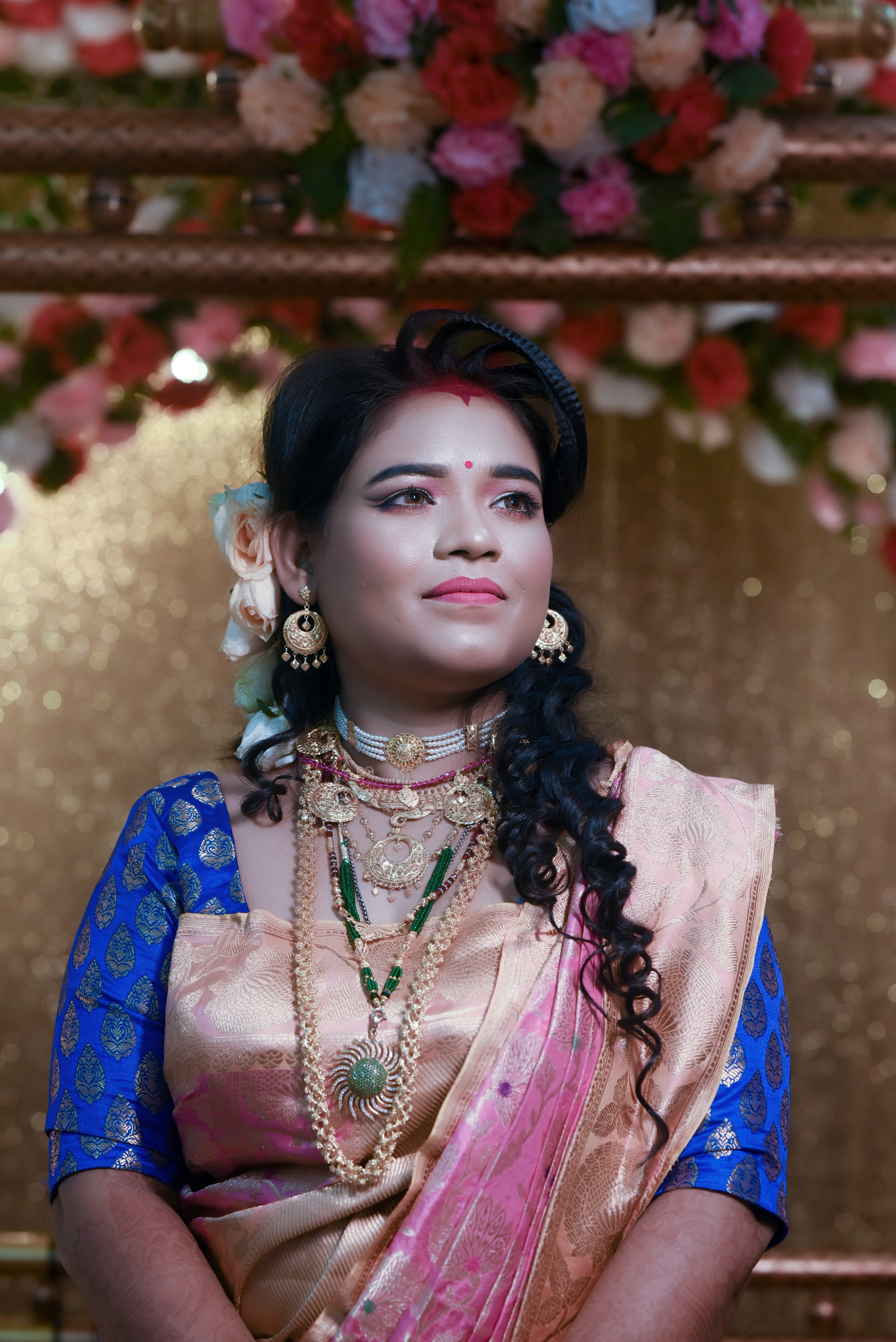 A woman in a blue and gold sari