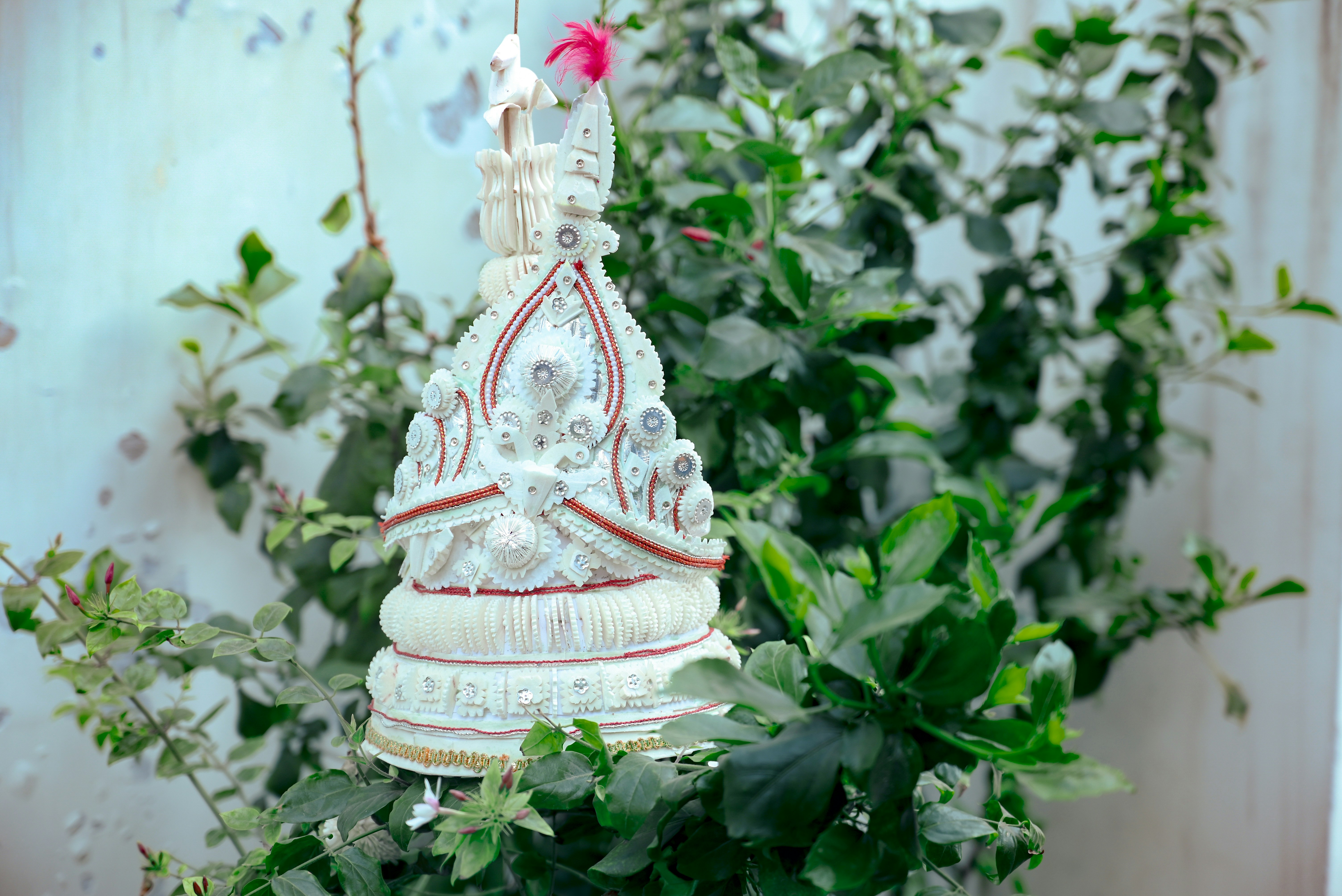 A white and red clock sitting on top of a table