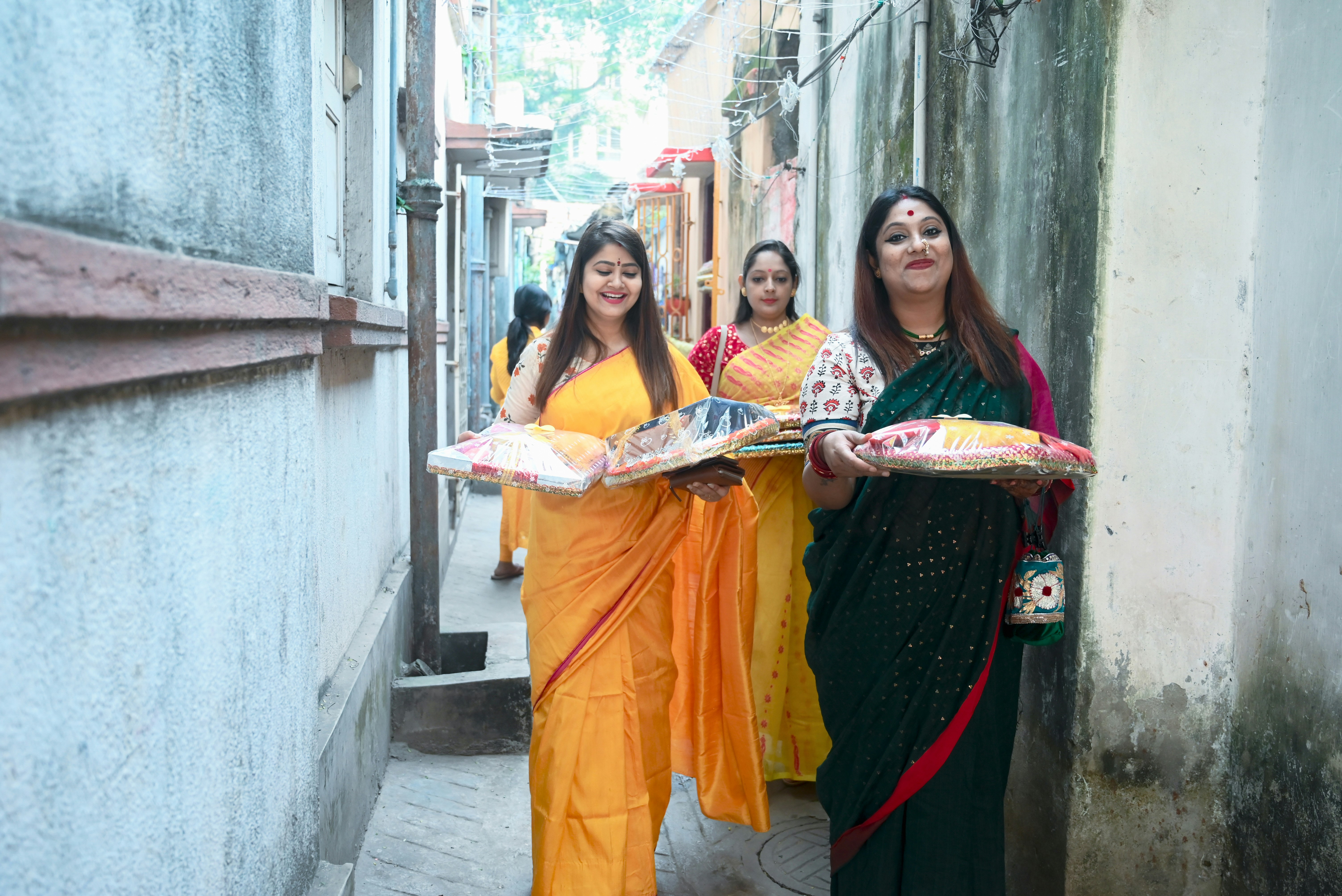 A group of women walking down a street next to each other