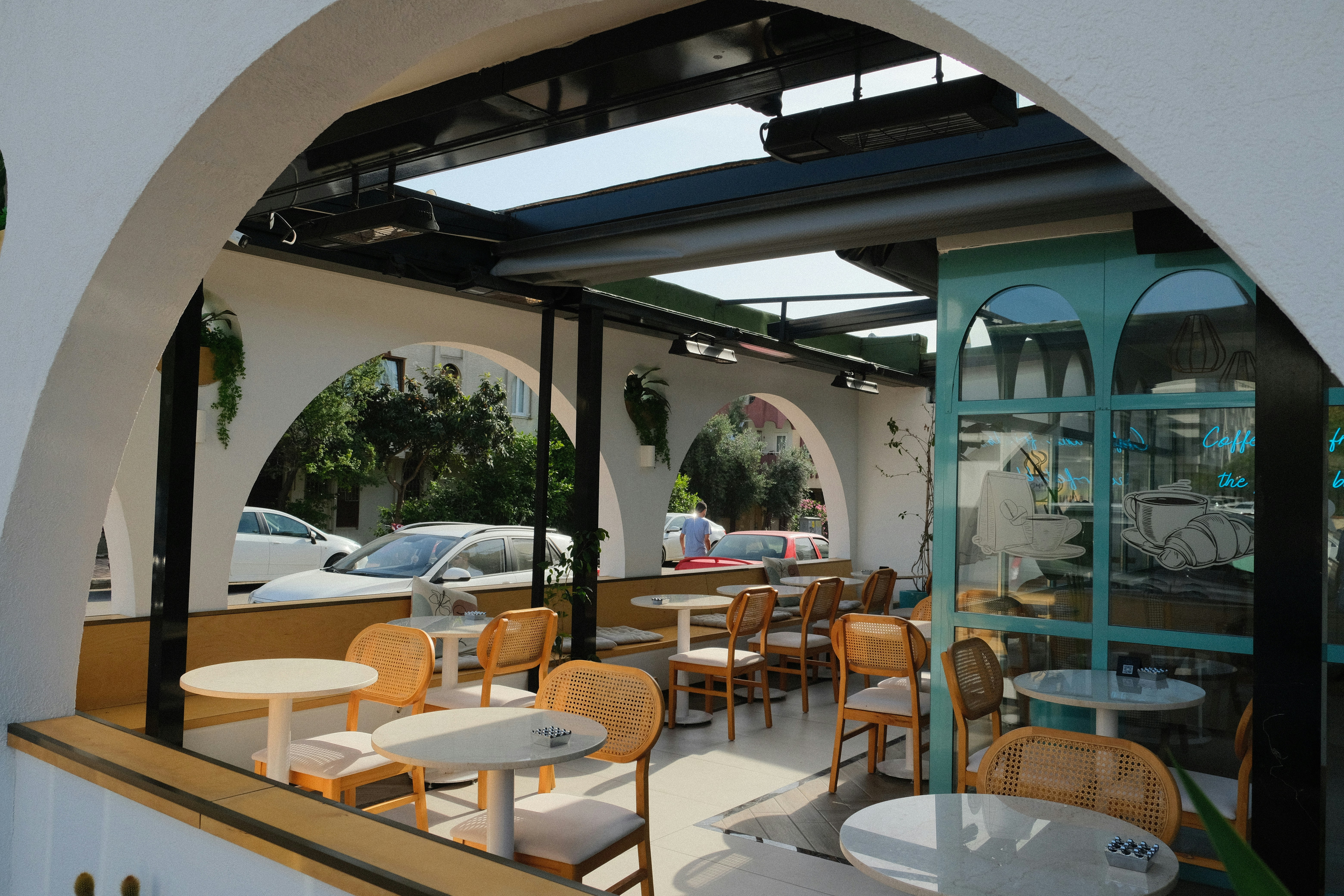 A restaurant with tables and chairs and a skylight
