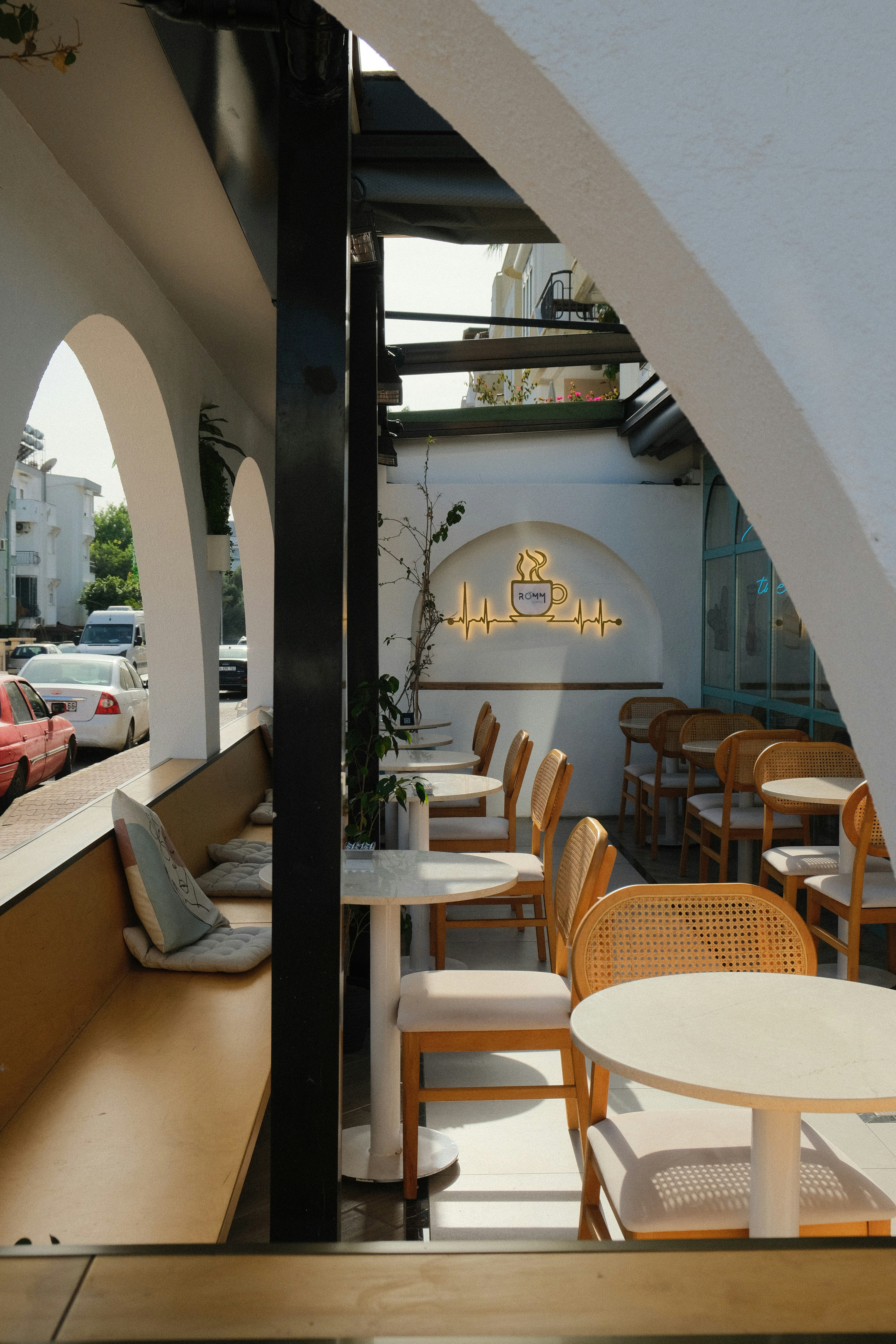 A restaurant with tables and chairs outside of it