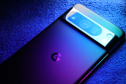 A close up of a cell phone on a blue surface