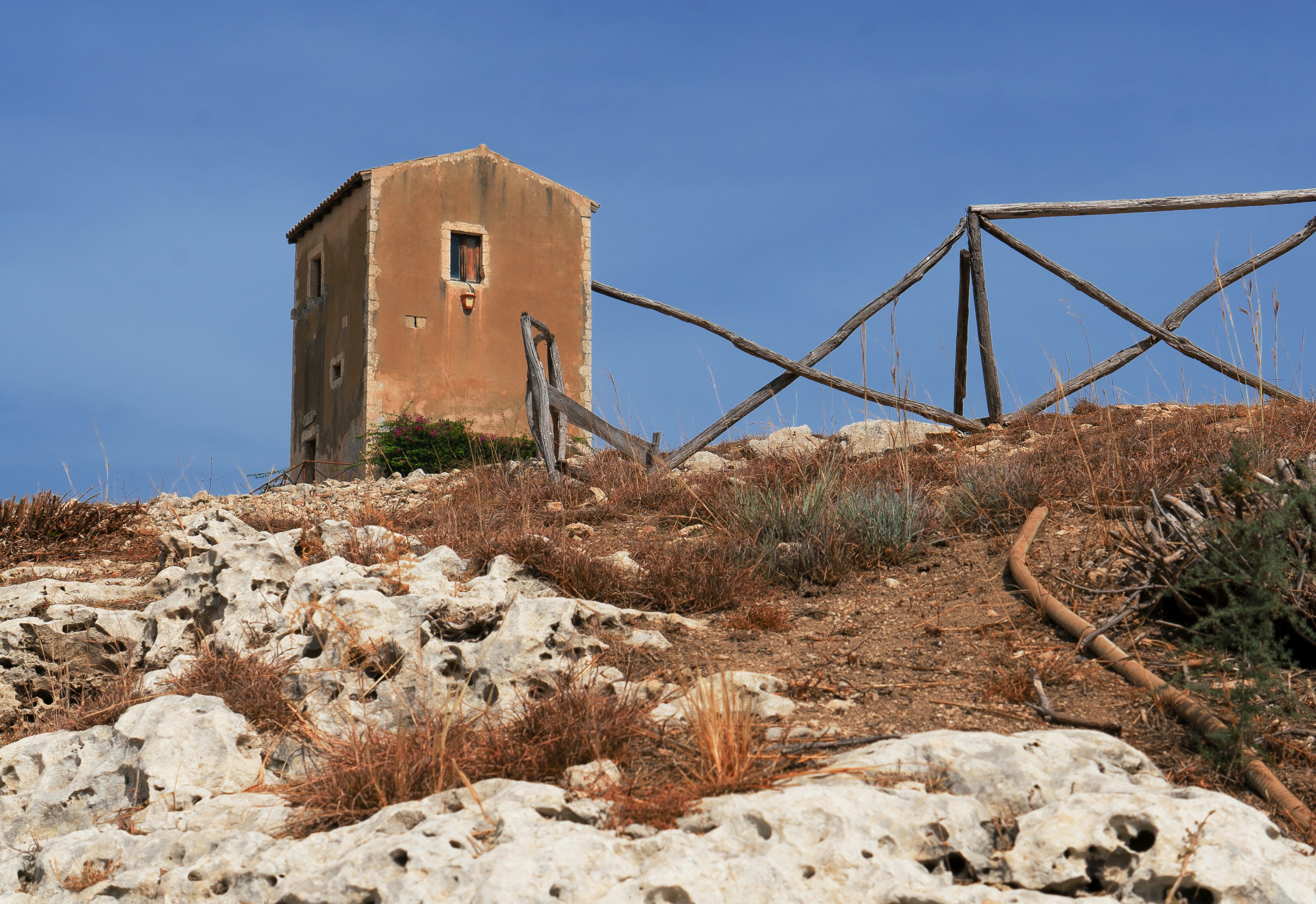 A small building sitting on top of a rocky hill