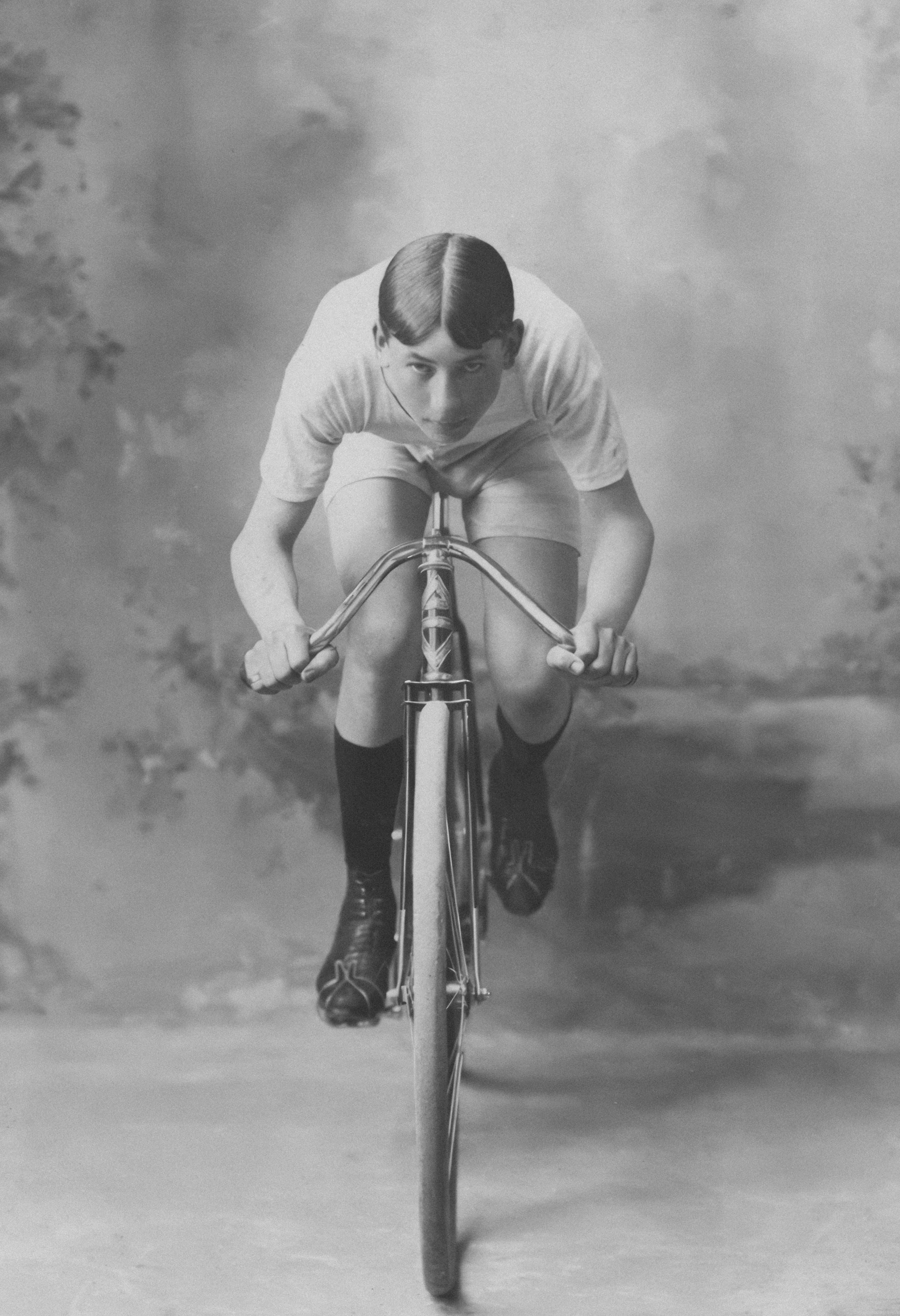 Young cyclist racing forward on vintage bicycle