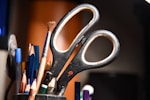 A cup full of pencils and scissors on a desk