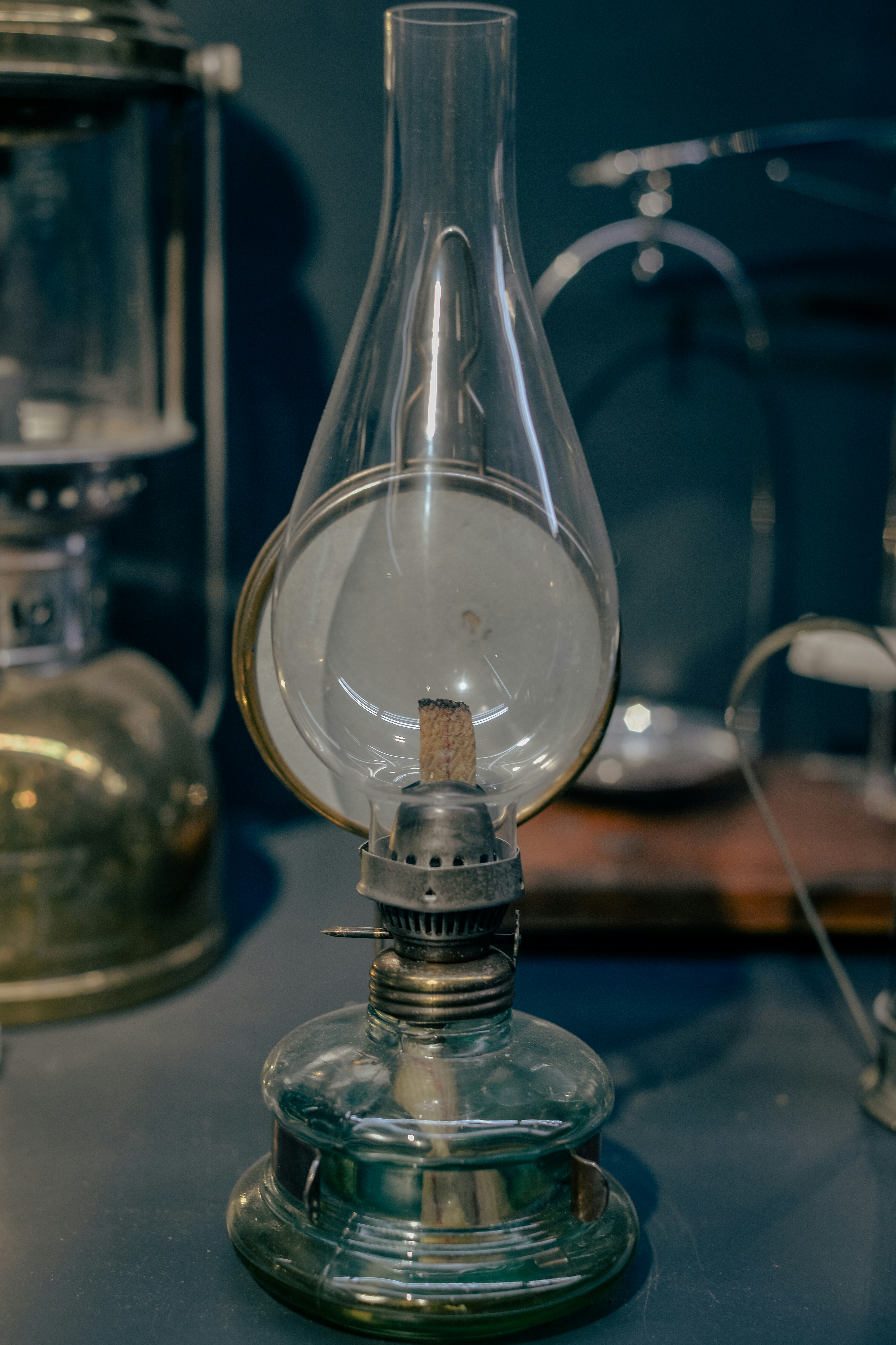 An old fashioned lamp is on a table