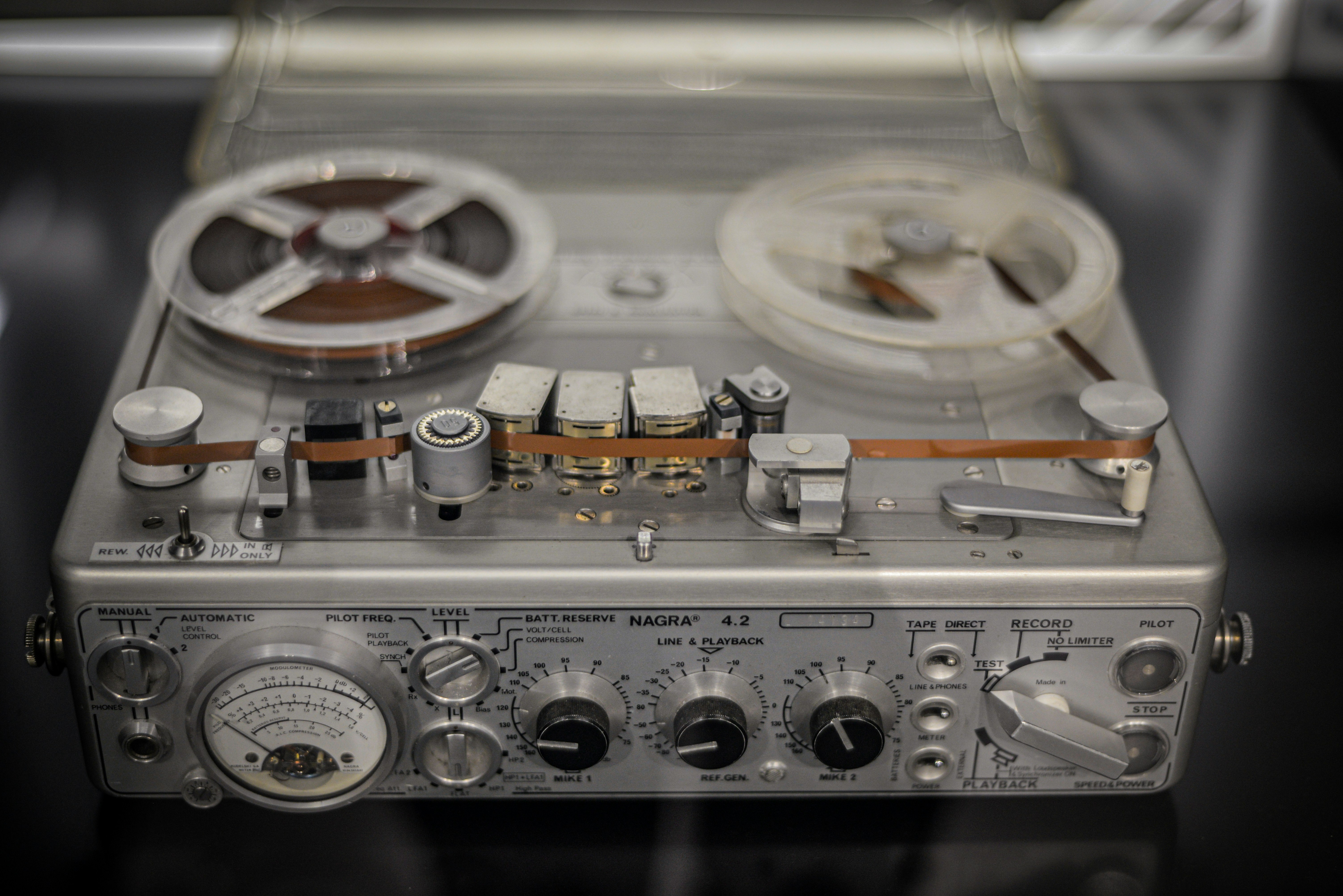 An old stereo with a reel on top of it