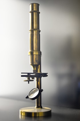 A magnifying glass sitting on top of a metal stand