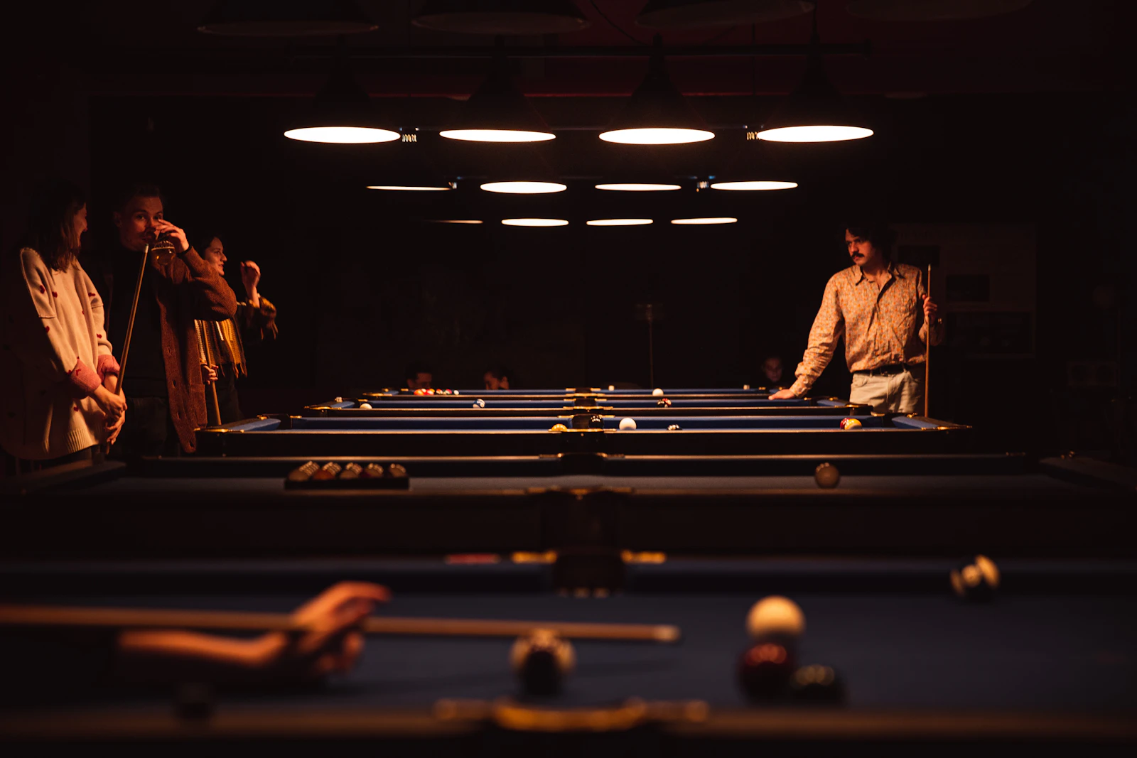 Friends gathered around a pool table