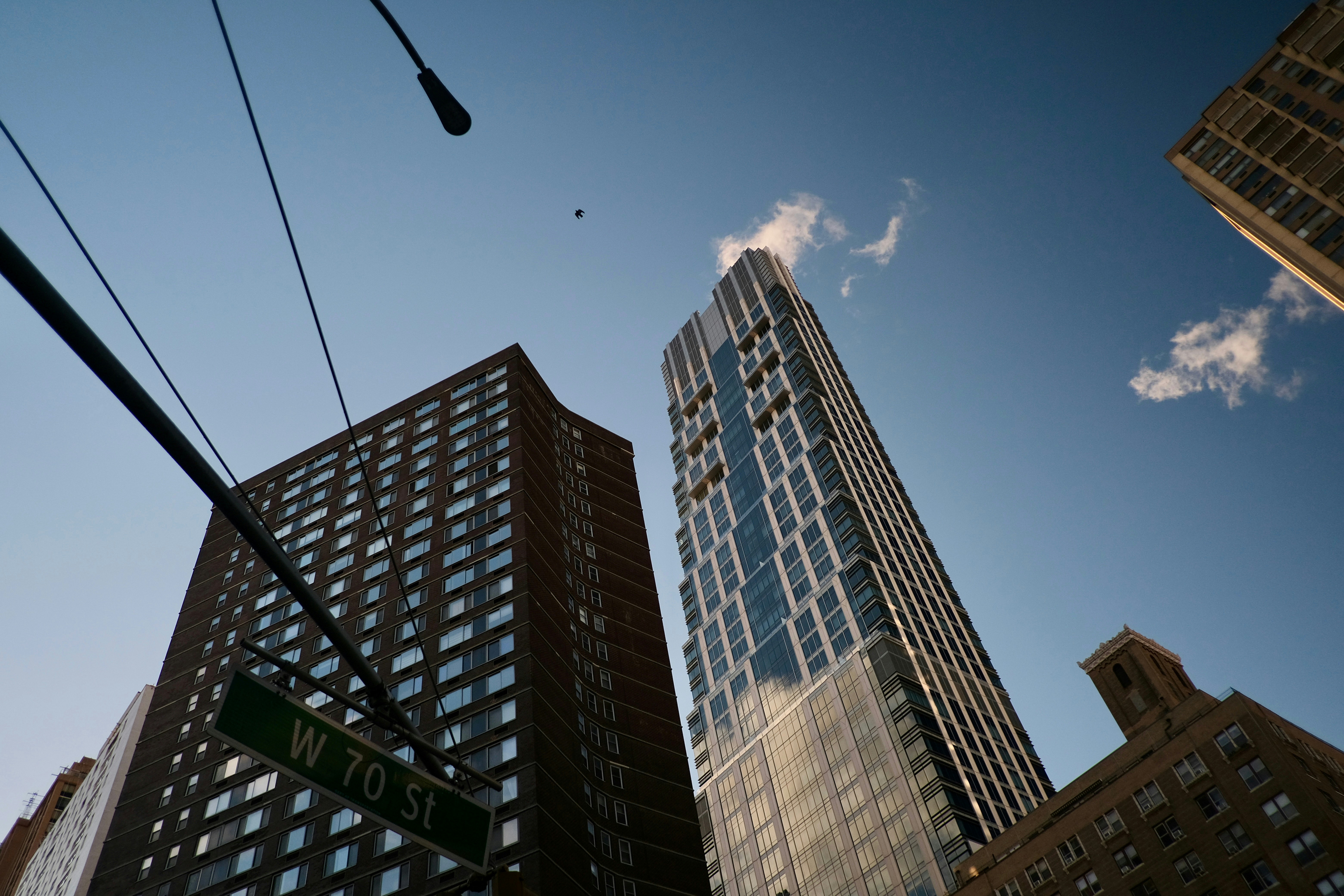 A street sign in front of some tall buildings