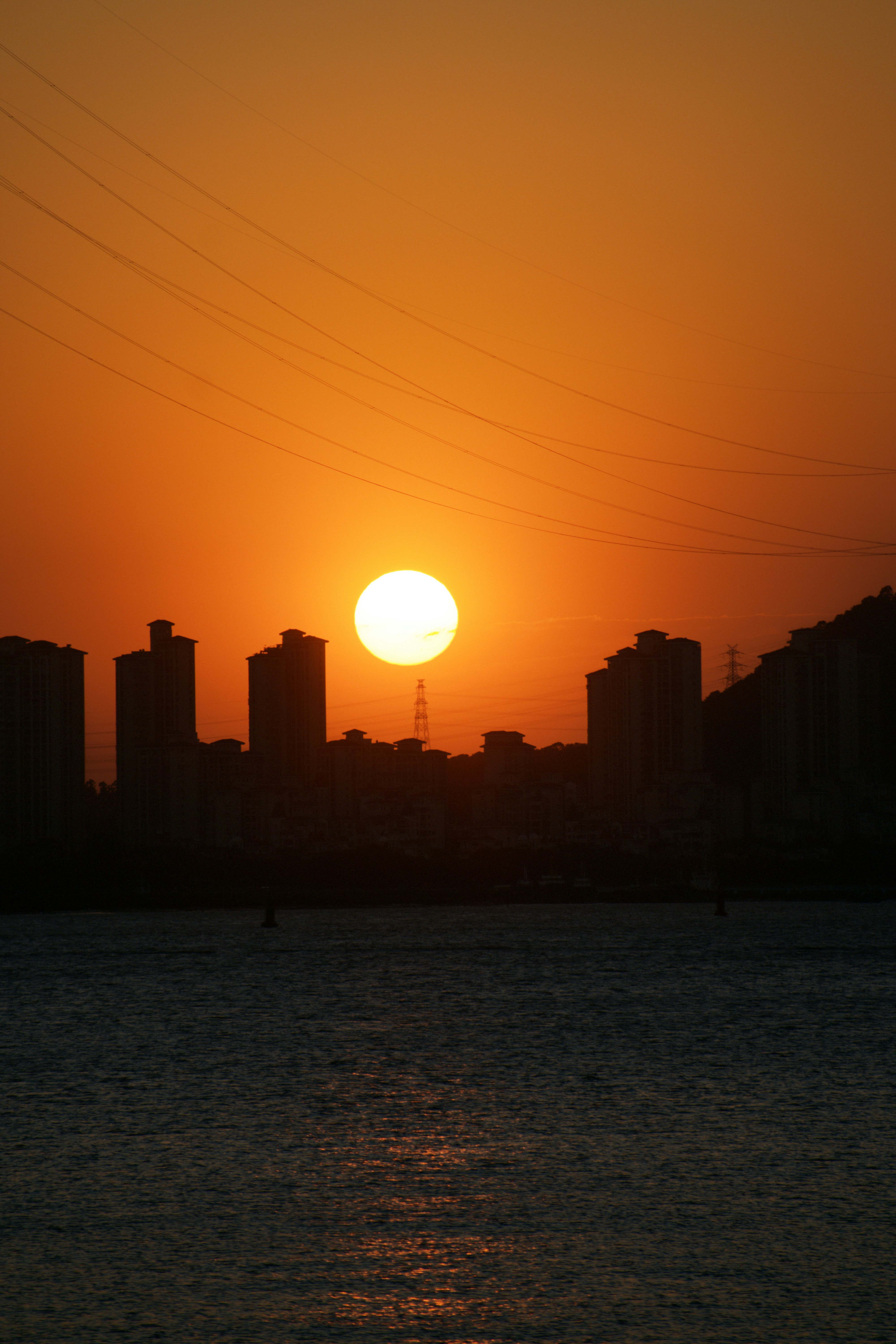 The sun is setting over the city skyline