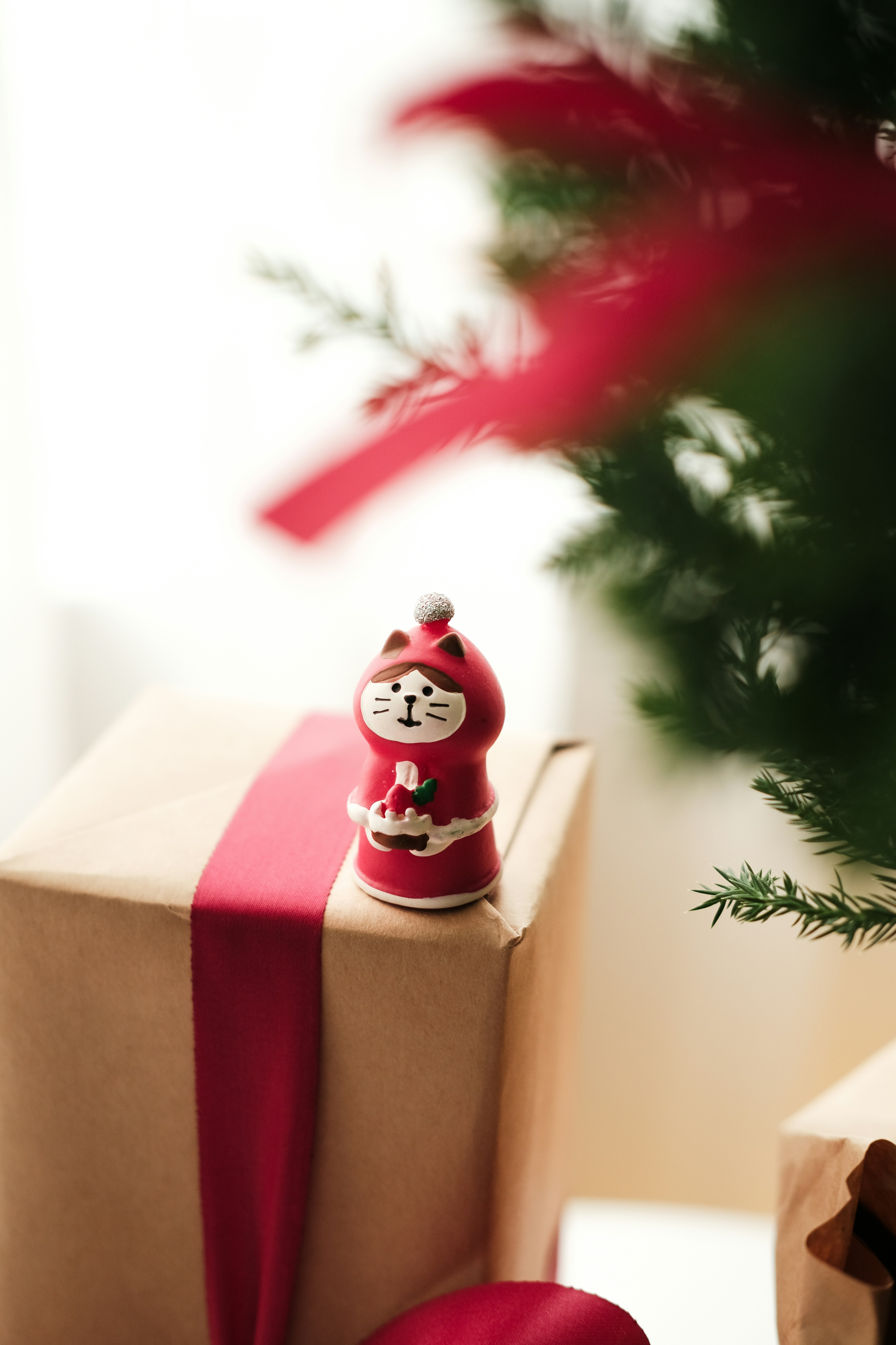 A present wrapped in brown paper with a red ribbon