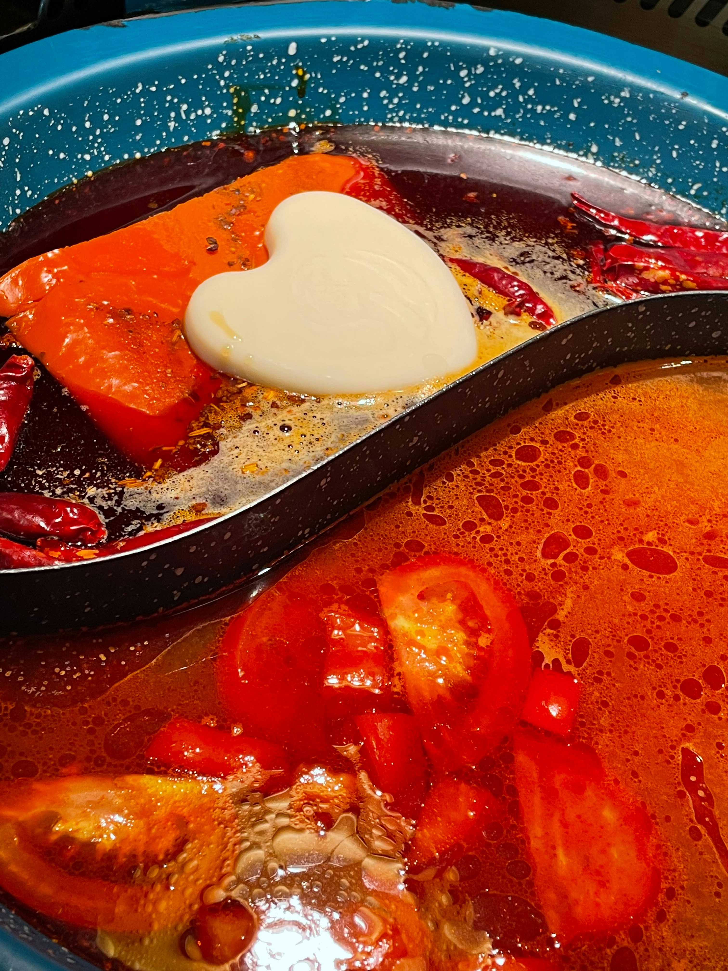 Sundubu jjigae soft tofu stew in a black stone pot bubbling with red chili broth