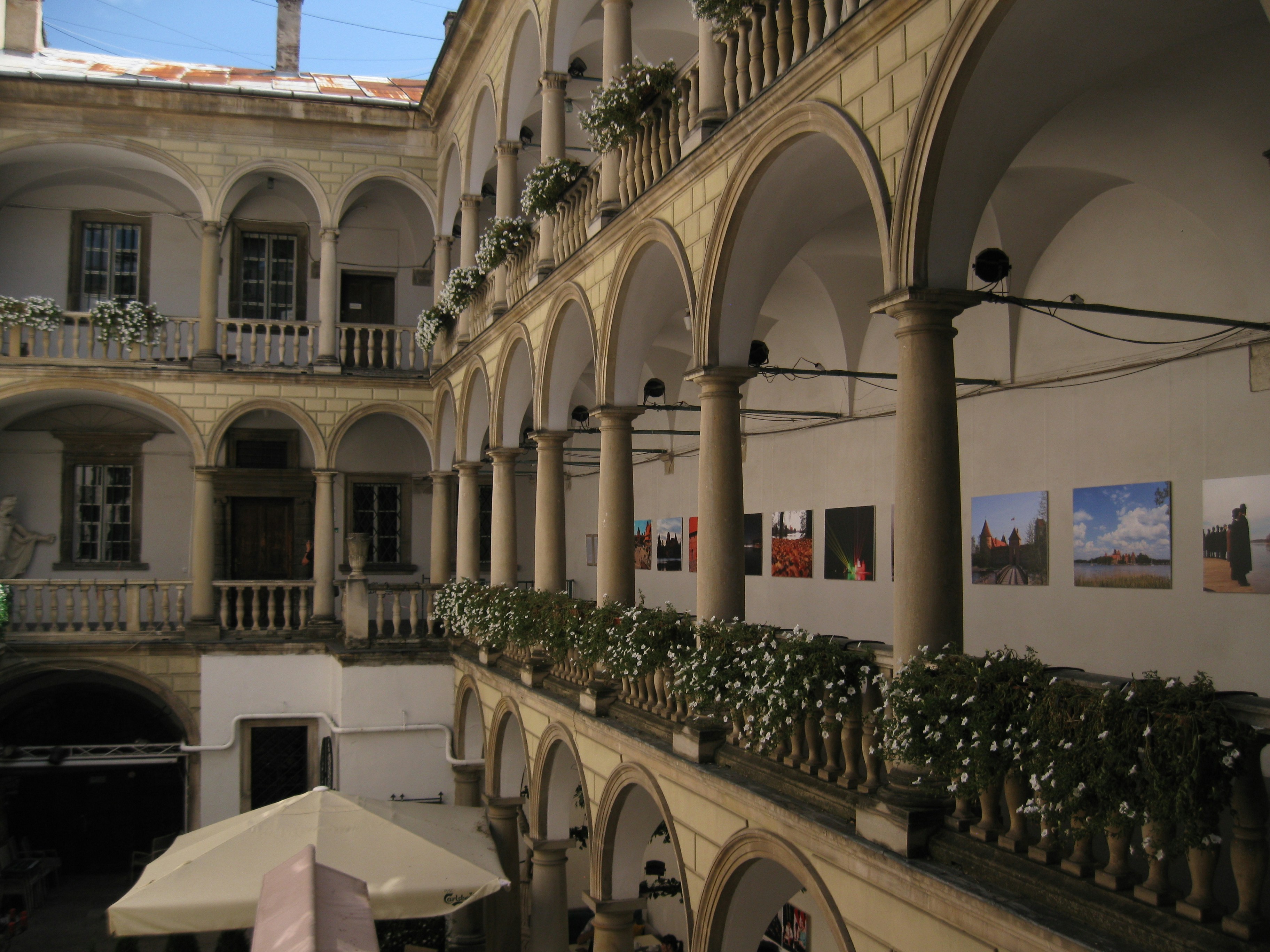A building with a bunch of arches and a white umbrella
