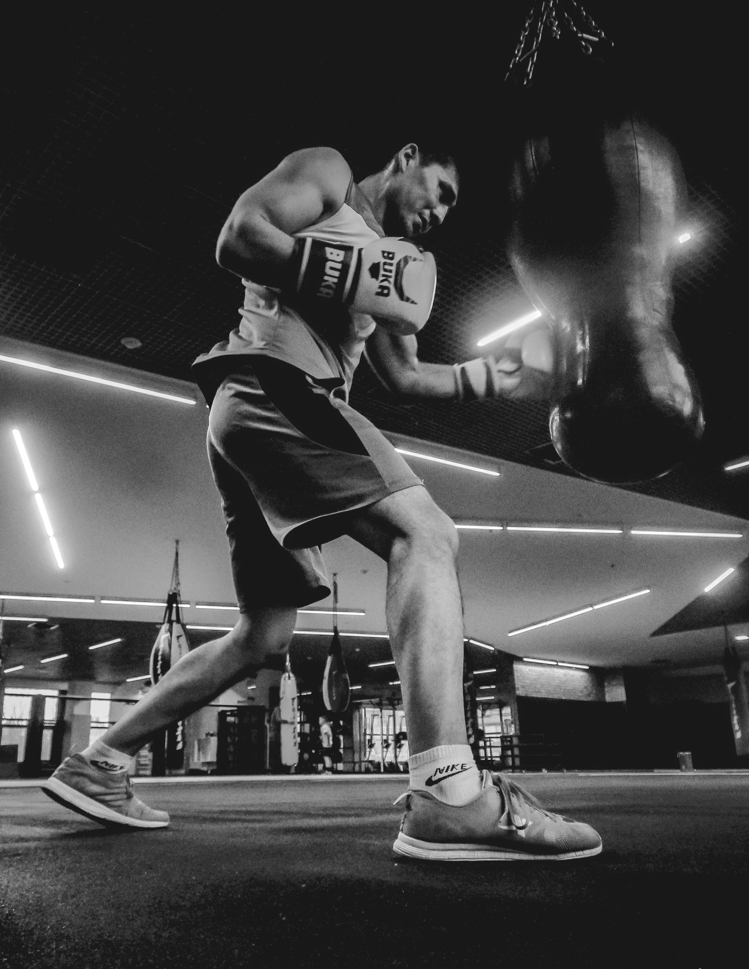 A black and white photo of a man in a boxing ring