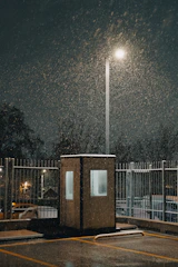 A parking lot covered in snow at night