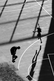 A person jumping up into the air on a basketball court